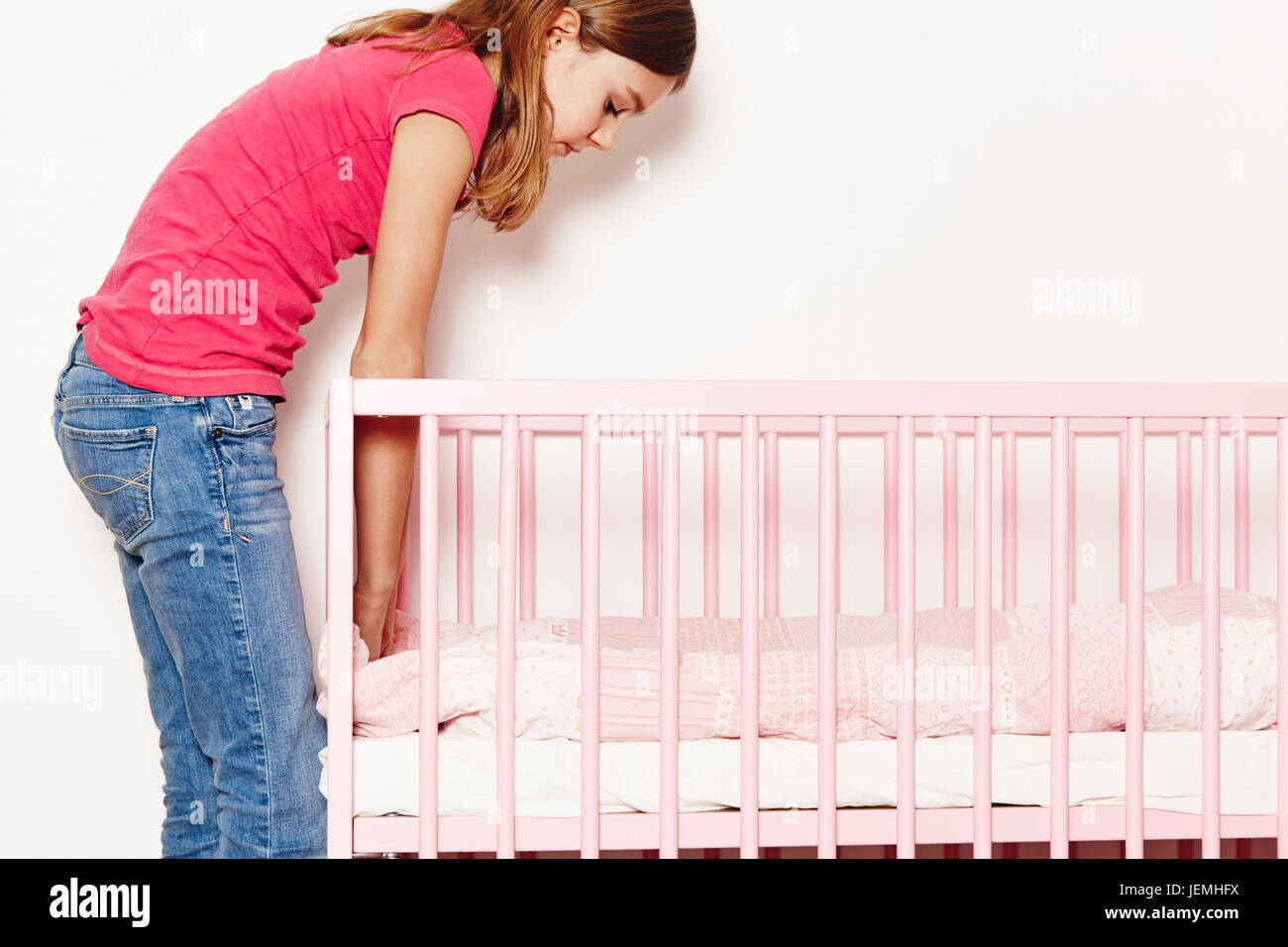 Girl doing bedding in cot Stock Photo Alamy
