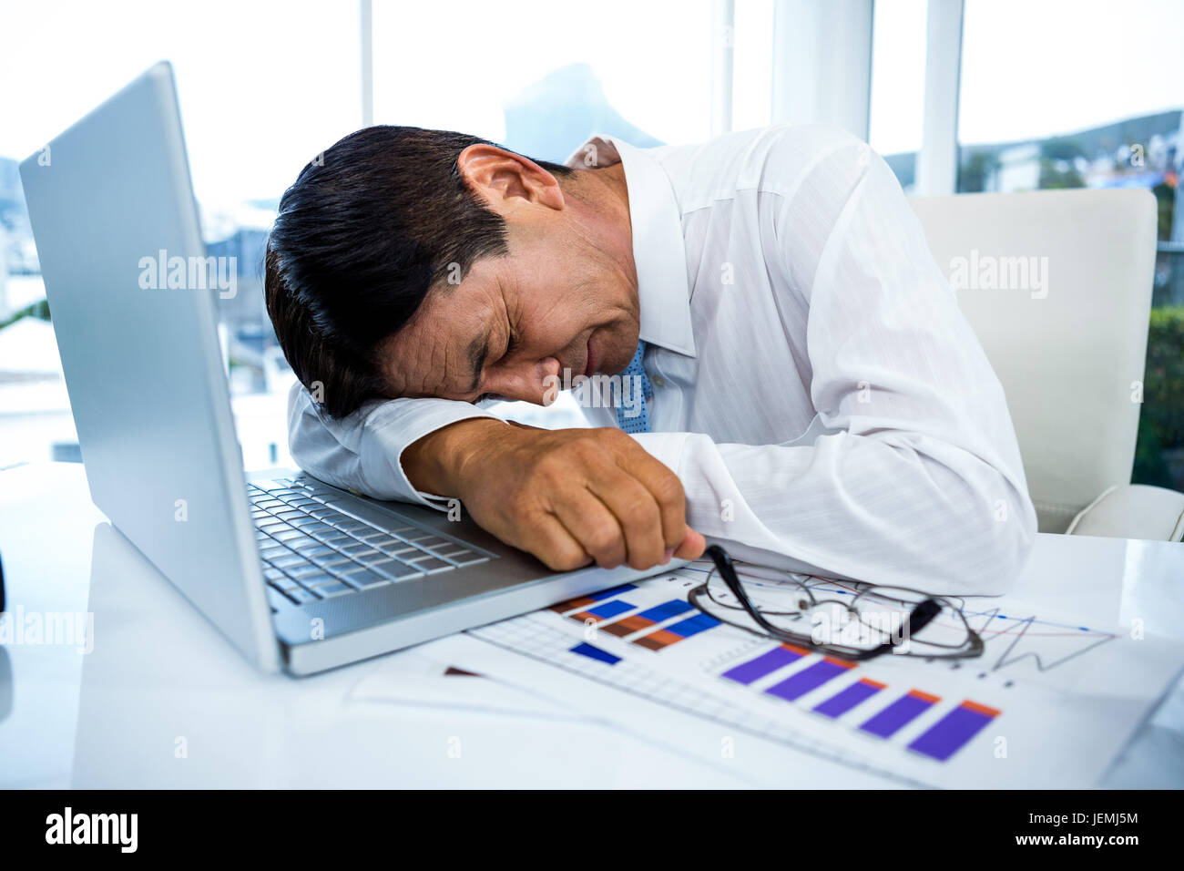 Exhausted businessman sleeping on his laptop Stock Photo Alamy