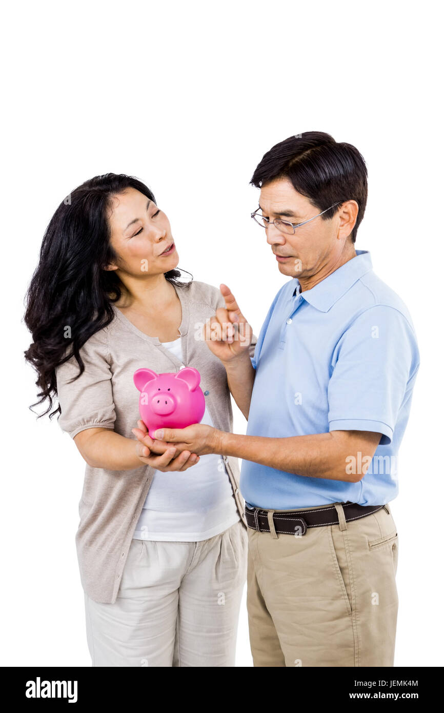 Happy couple holding a piggy bank Stock Photo - Alamy