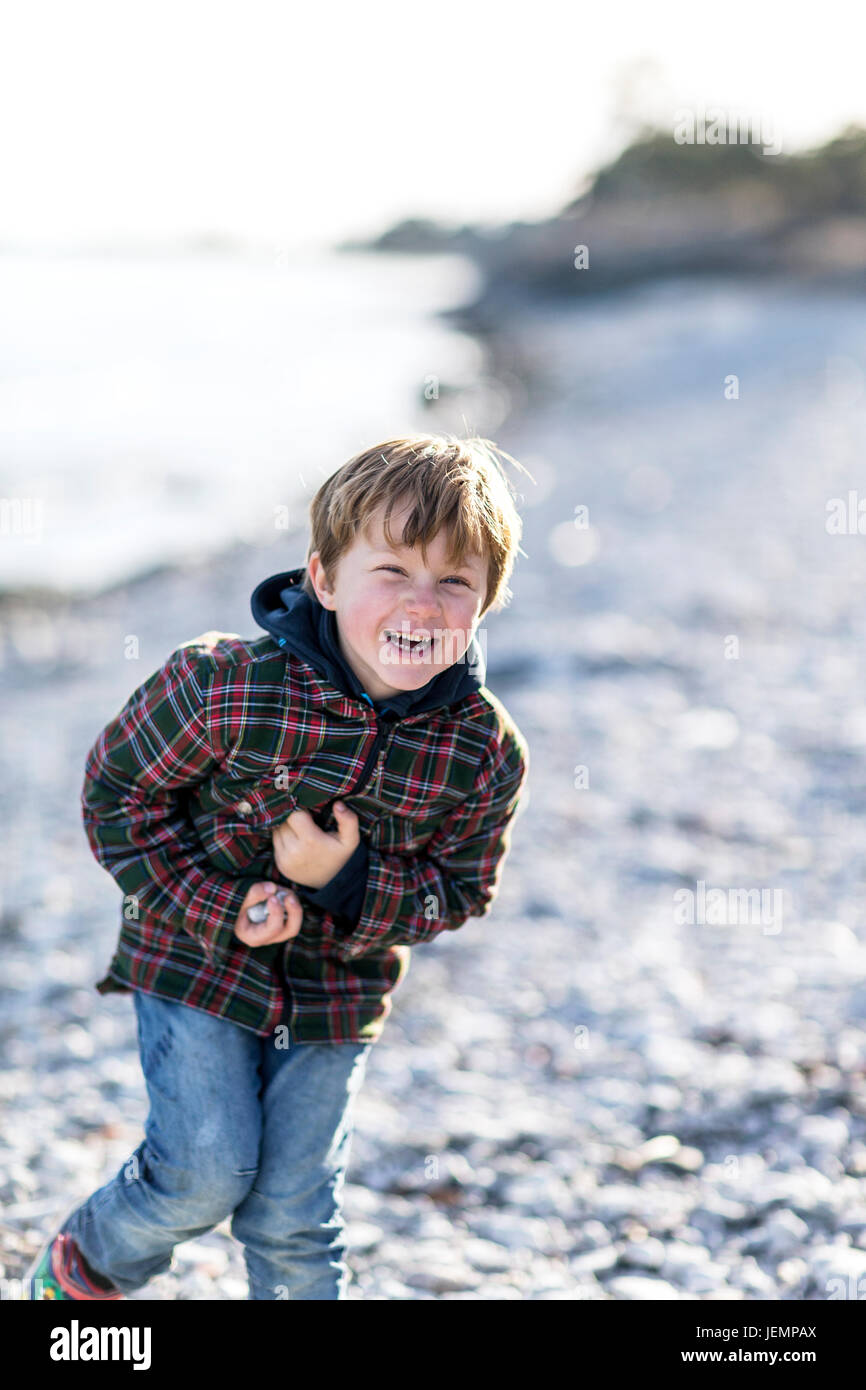 Laughing boy on beach Stock Photo Alamy