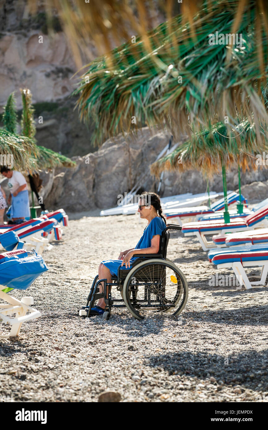 Senior woman on wheelchair on beach Stock Photo