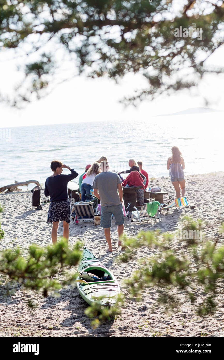 Family having meal on beach Stock Photo - Alamy