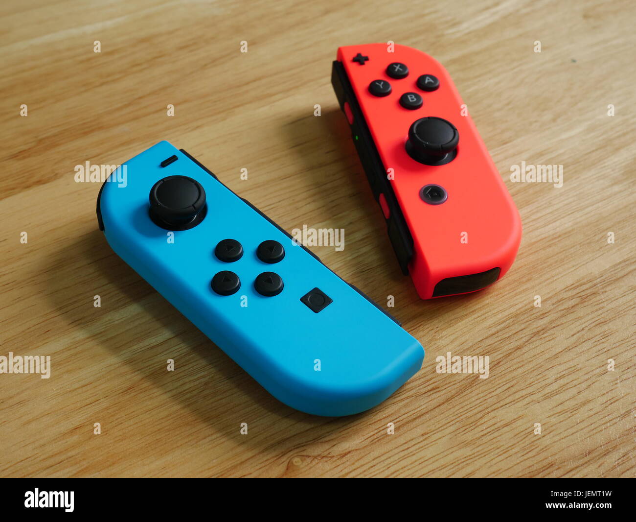 Bangkok, Thailand - June 25, 2017 : Nintendo Switch controllers on wooden table. Stock Photo