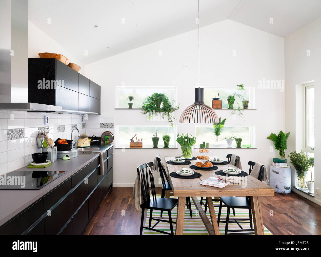 Modern kitchen with dining table Stock Photo - Alamy