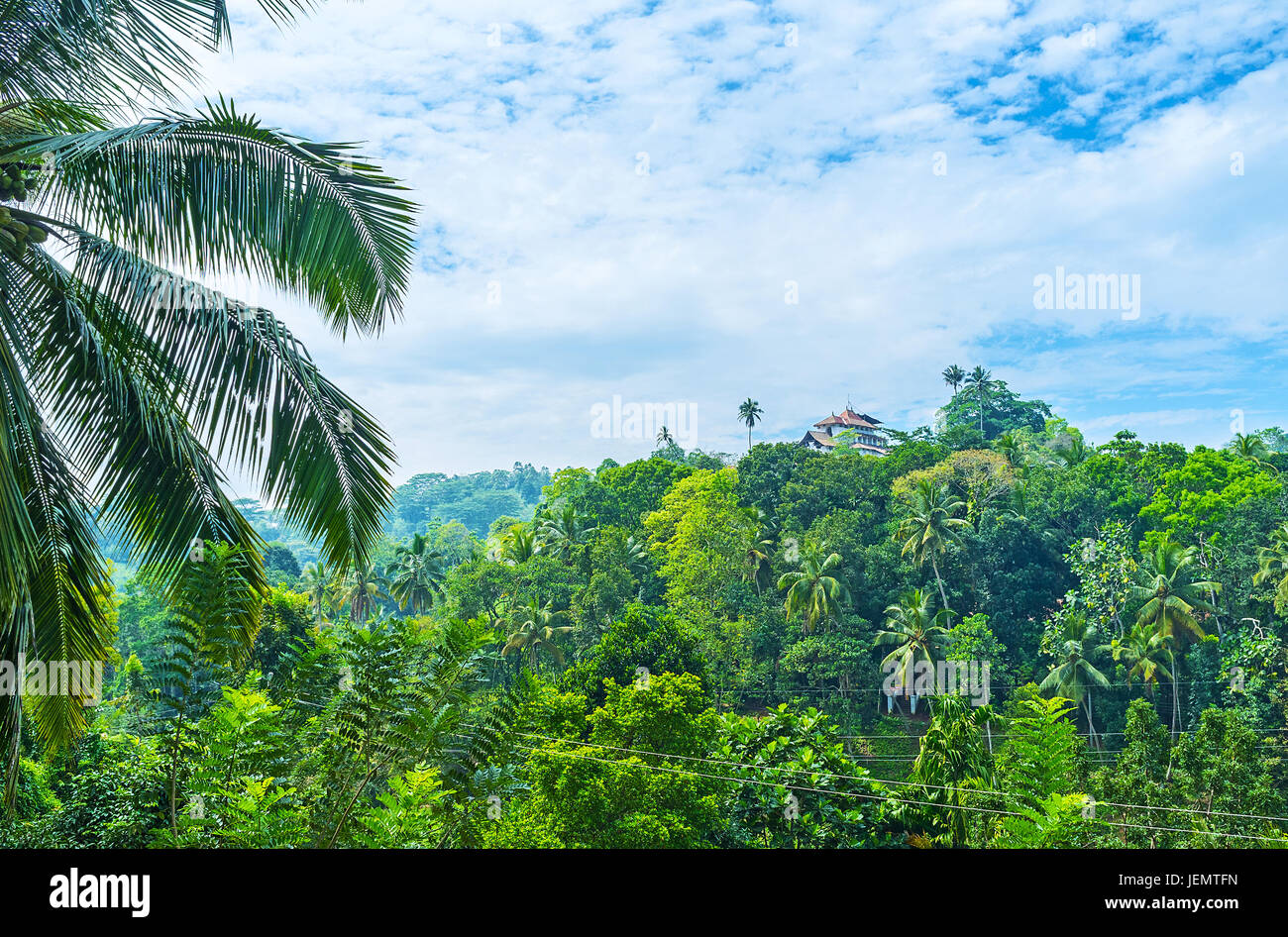 Lankathilaka Vihara, located on the top of Panhalgala Rock is almost hidden in lush greenery of jungles, Udunuwara, Sri Lanka. Stock Photo