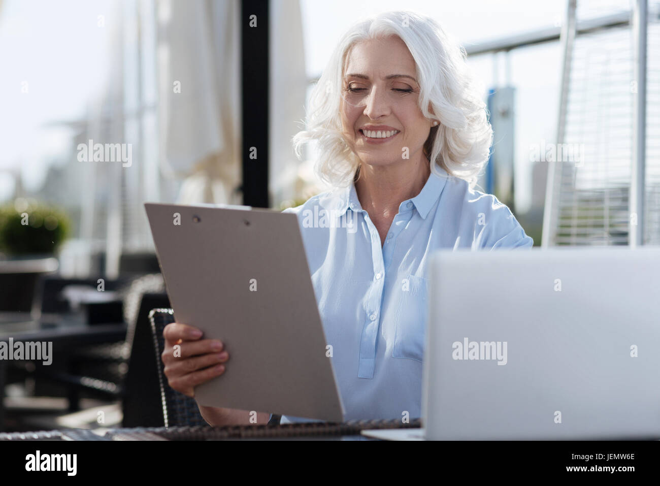 Elderly woman holding documents hi-res stock photography and images - Alamy