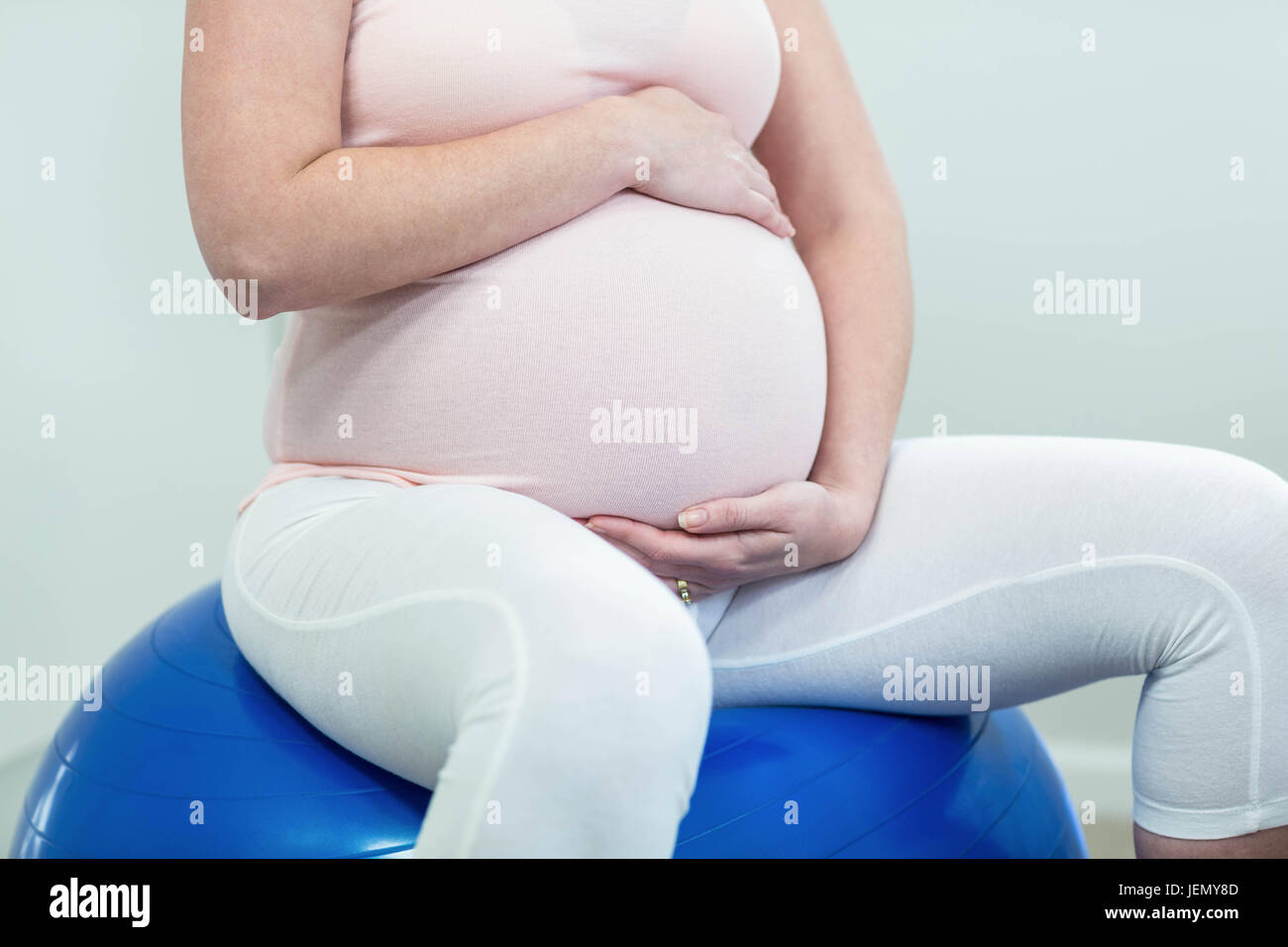 Pregnant woman sitting on exercise ball Stock Photo Alamy