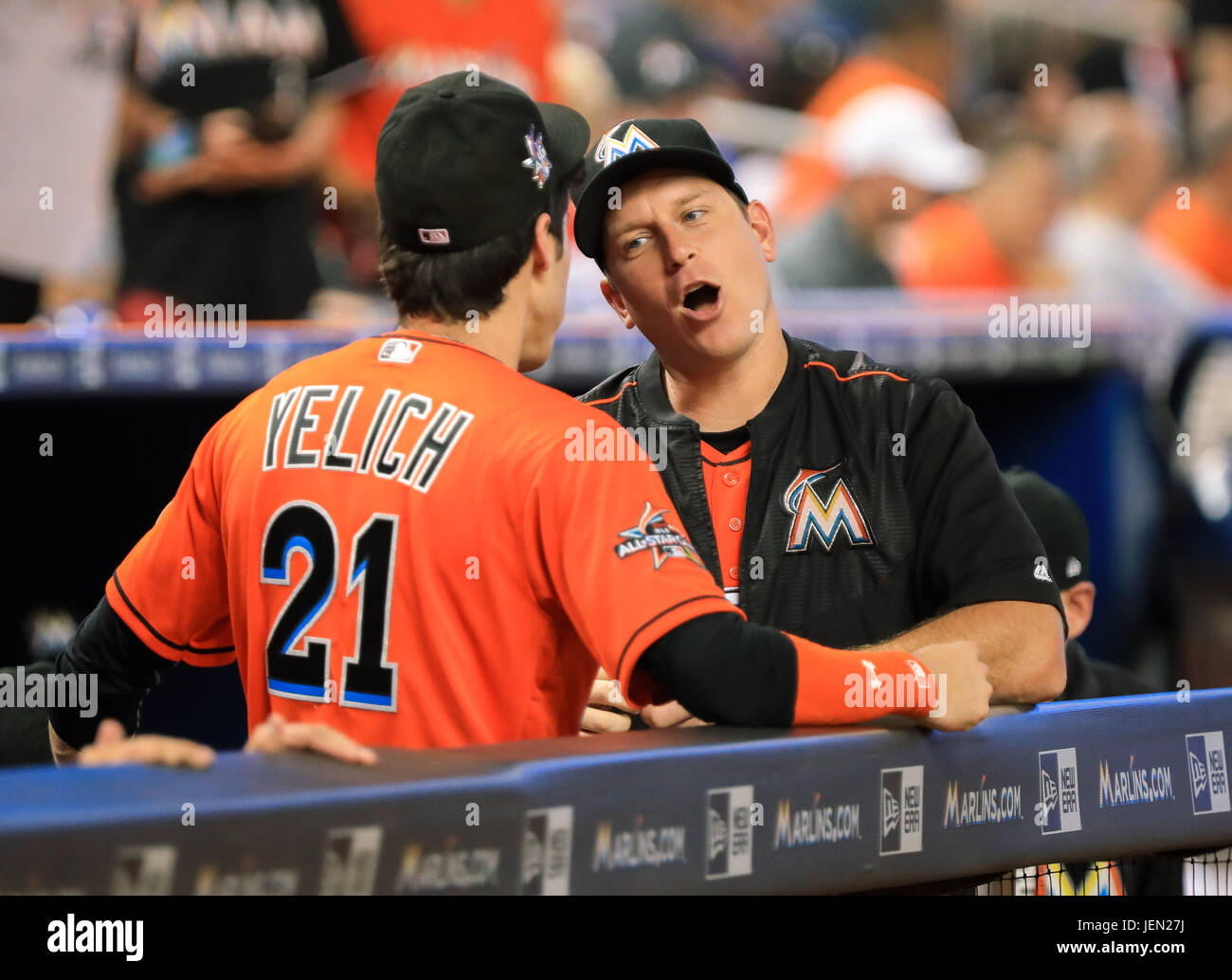 Miami, Florida, USA. 25th June, 2017. Miami Marlins catcher A.J. Ellis  (17), right, converse in the dugout with Miami Marlins center fielder  Christian Yelich (21), left, during a MLB game between the