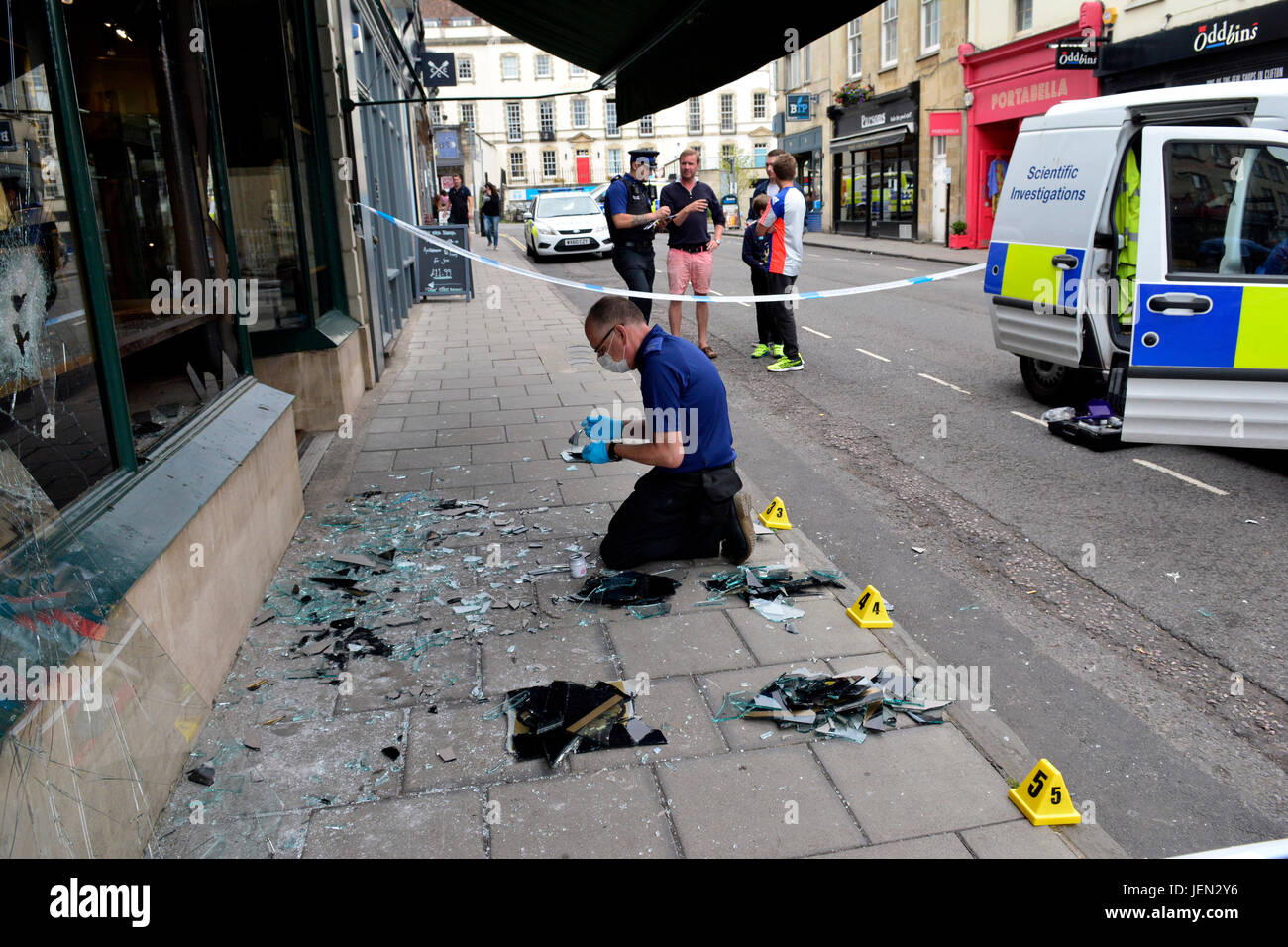Bristol, UK. 26th June,  2017. People reported seeing armed men on motorbikes smash the windows of Grey-Harris and Co Jewelers and make off at speed with jewellery. Princess Victoria Street was closed while forensic team sifted through the damaged jewelers. John Woodcock who works nearby Johnson's cleaners,described the moment a man with an Axe came towards him. The afternoon was packed with shoppers. Credit: Robert Timoney/Alamy Live News Stock Photo