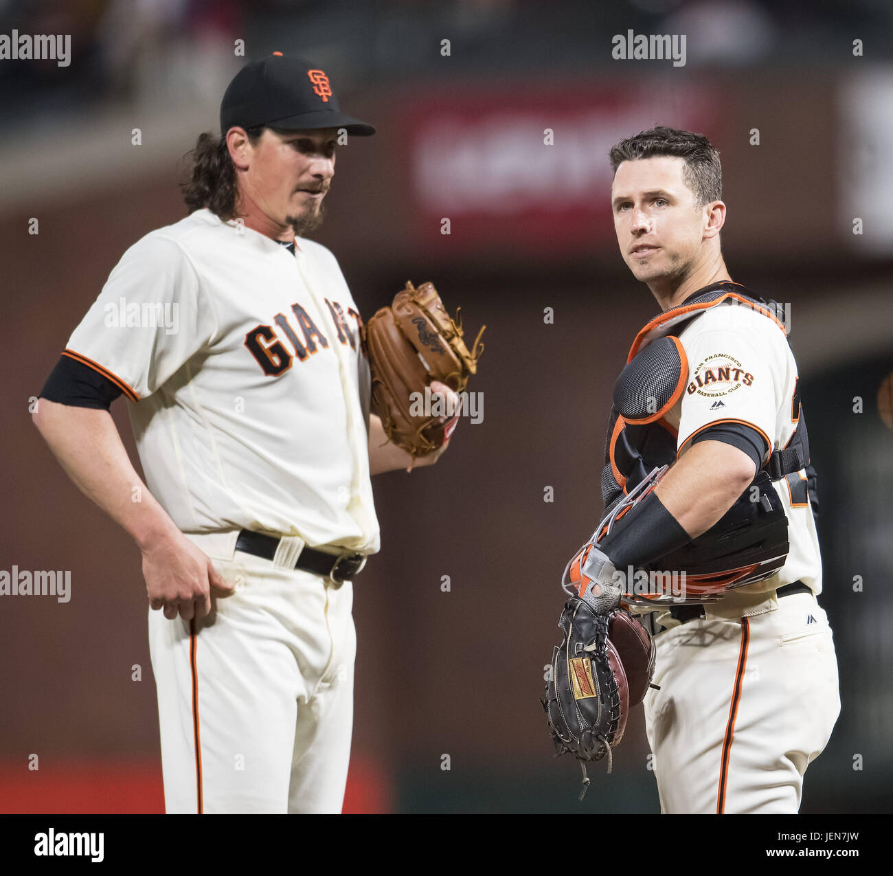 San Francisco, California, USA. 26th June, 2017. San Francisco Giants catcher Buster Posey (28) looks to the dugout while meeting with San Francisco Giants starting pitcher Jeff Samardzija (29) at the mound, during a MLB baseball game between the Colorado Rockies and the San Francisco Giants on LGBT Night at AT&T Park in San Francisco, California. Valerie Shoaps/CSM/Alamy Live News Stock Photo