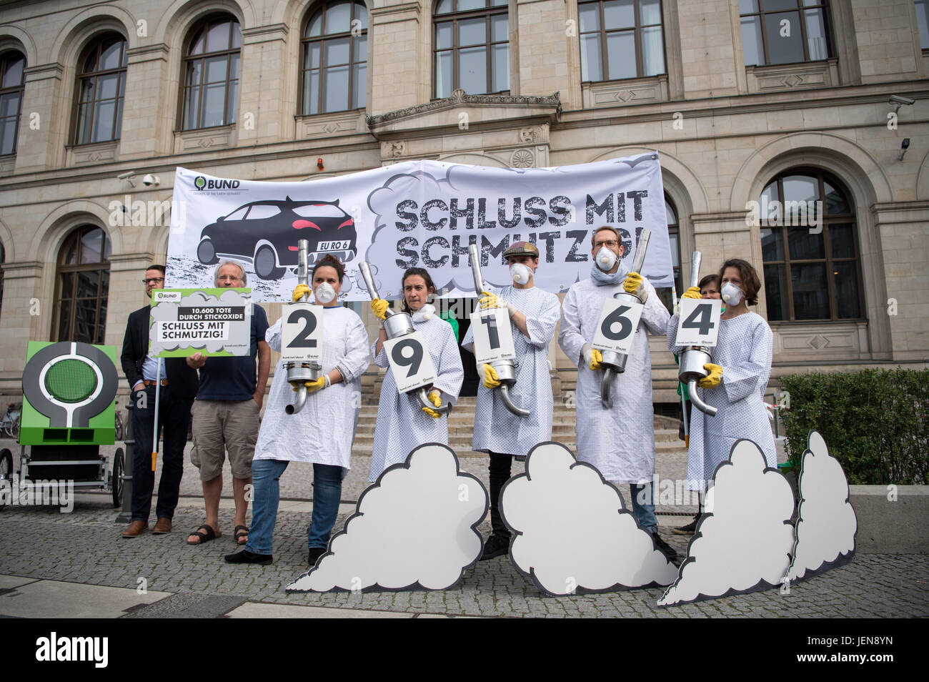 Berlin, Germany. 27th June, 2017. Eight activists of the Association for the Environment and Nature Protection Germany (BUND) hand over a petition titled 'Schluss mit schmutzig!' ('End the dirt!'), signed by 29,164 participants, demanding a stop of the sale of Diesel cars with an extreme exhaust emission from German Minister of Traffic Dobrindt. Photo: Bernd von Jutrczenka/dpa/Alamy Live News Stock Photo