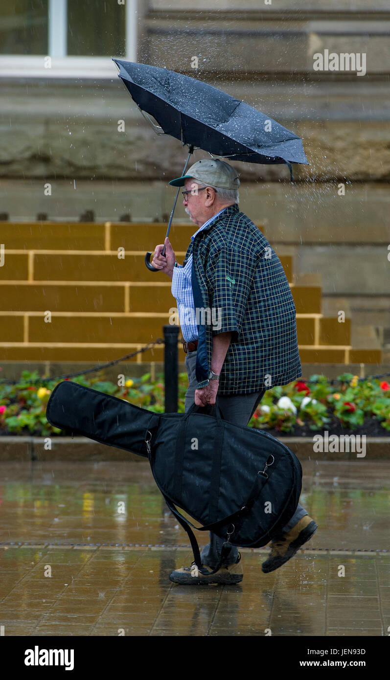 Bolton, Lancashire, UK. 27th June, 2017. It was definitely an umbrella day as a filthy wet morning greeted shoppers and people going to work through Victoria Square in Bolton, Lancashire, UK. The north west of England has been issued with a yellow warning for torrential rain for the next 24 hours. Picture by Paul Heyes, Tuesday June 27, 2017. Credit: Paul Heyes/Alamy Live News Stock Photo