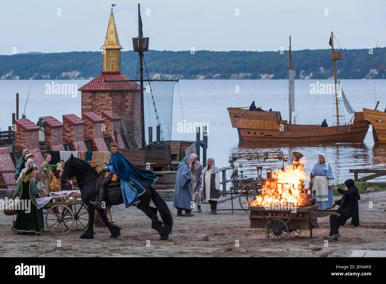 Bastian Semm as pirate Klaus Stoertebeker rides past a burning market stand at the nature stage in Ralswiek on Ruegen island, Germany, 21 June 2017. Tis year's production titled 'Im Schatten des Todes' (lit. 'In the Shadow of Death') premieres on 24 June 2017. The Stoertebeker Festival (German: 'Stoertebeker Festspiele') have been taken place for 25 years on Ruegen island. Photo: Jens Büttner/dpa-Zentralbild/dpa Stock Photo