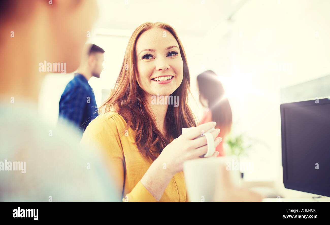 happy creative team drinking coffee at office Stock Photo