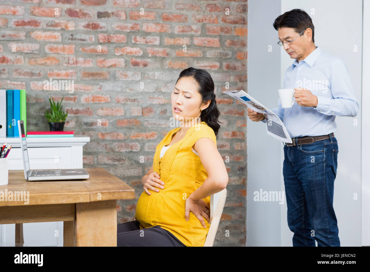 Suffering pregnant woman sitting on chair Stock Photo Alamy