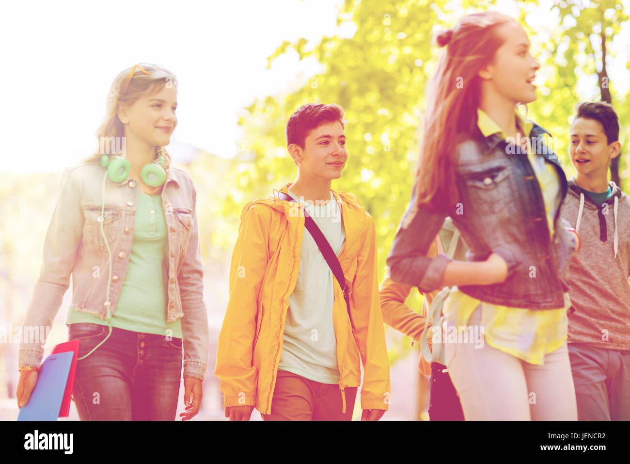 group of happy teenage students walking outdoors Stock Photo - Alamy