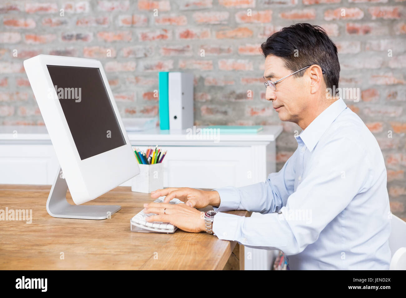 Serious man using computer Stock Photo - Alamy
