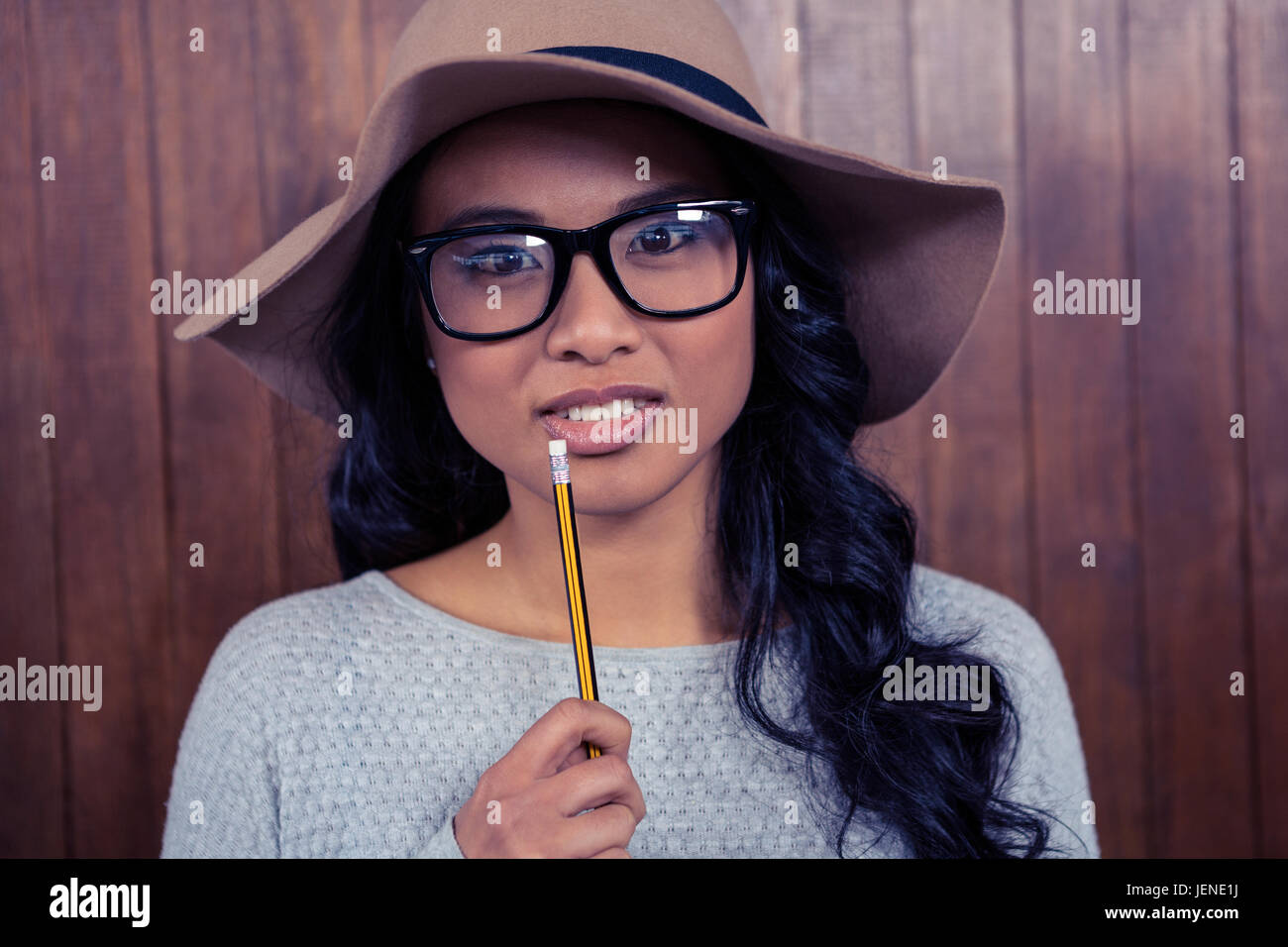 Woman thinking holding pencil hi-res stock photography and images - Alamy