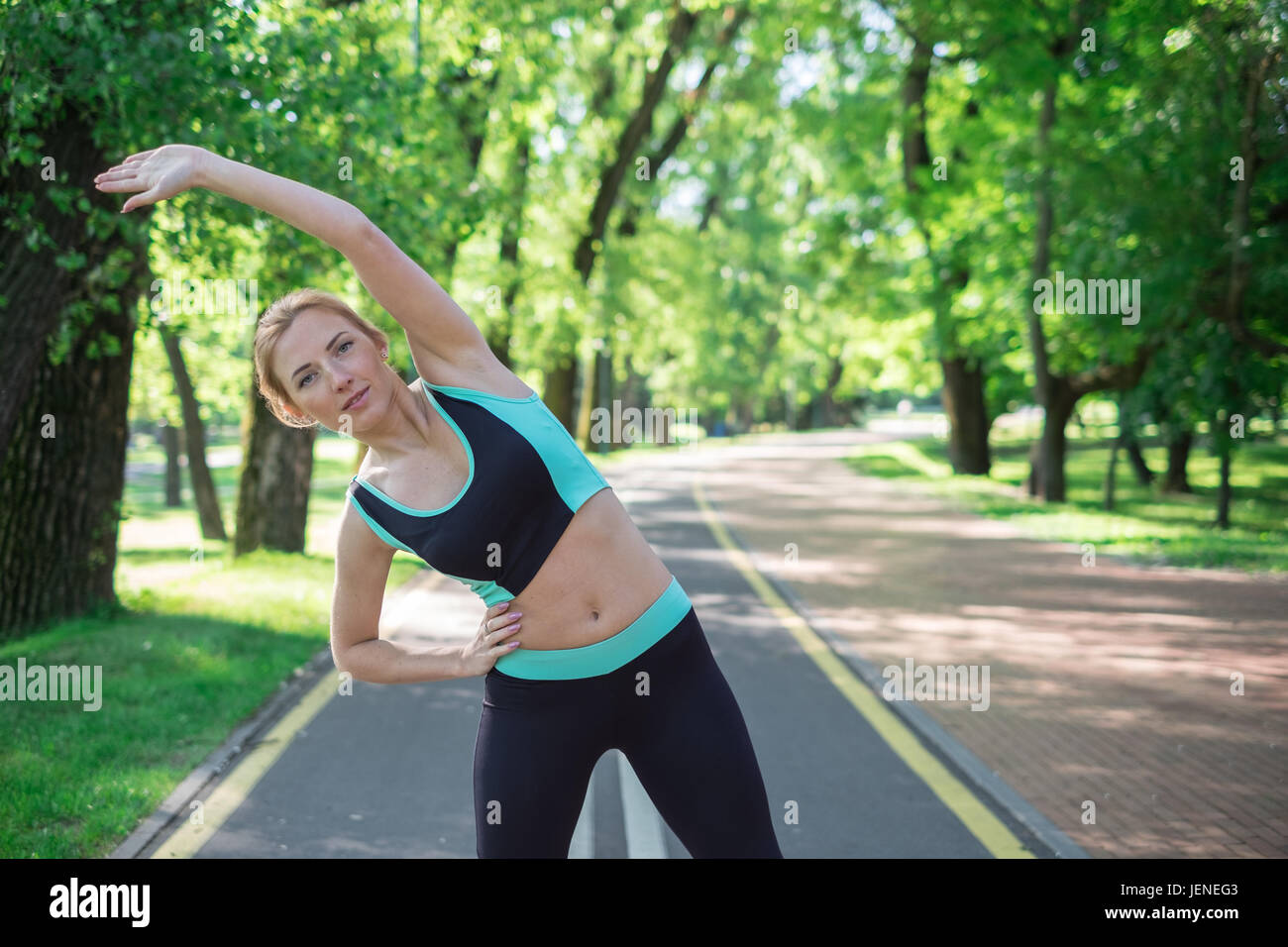 Beautiful young woman stretching in hi-res stock photography and images ...