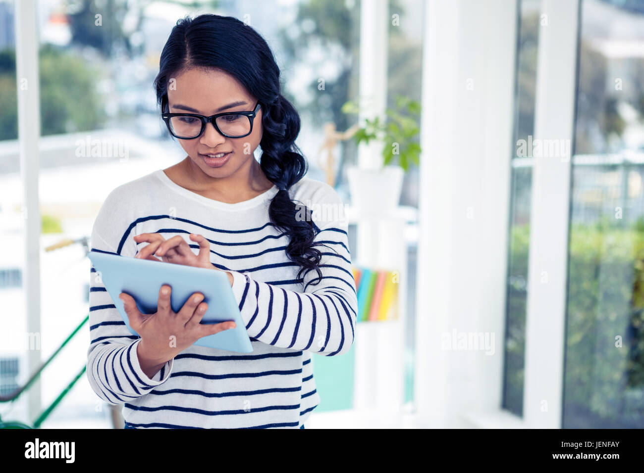 Attractive Asian woman using tablet Stock Photo - Alamy