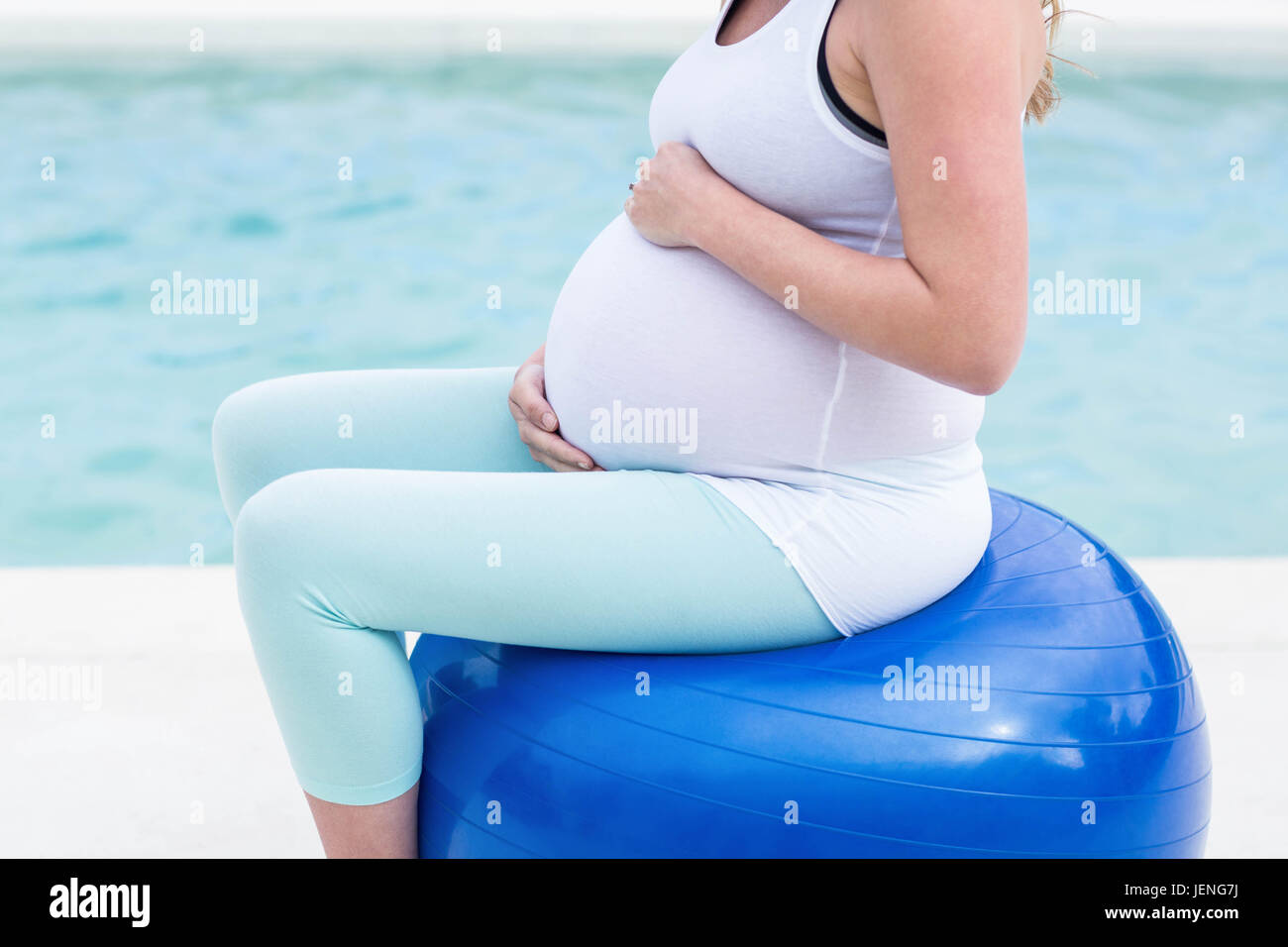 Pregnant woman sitting on exercise ball Stock Photo Alamy