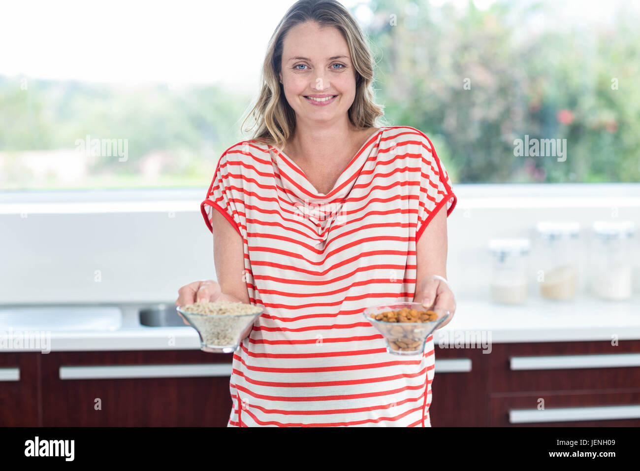 Pregnant woman showing bowls of cereals Stock Photo Alamy
