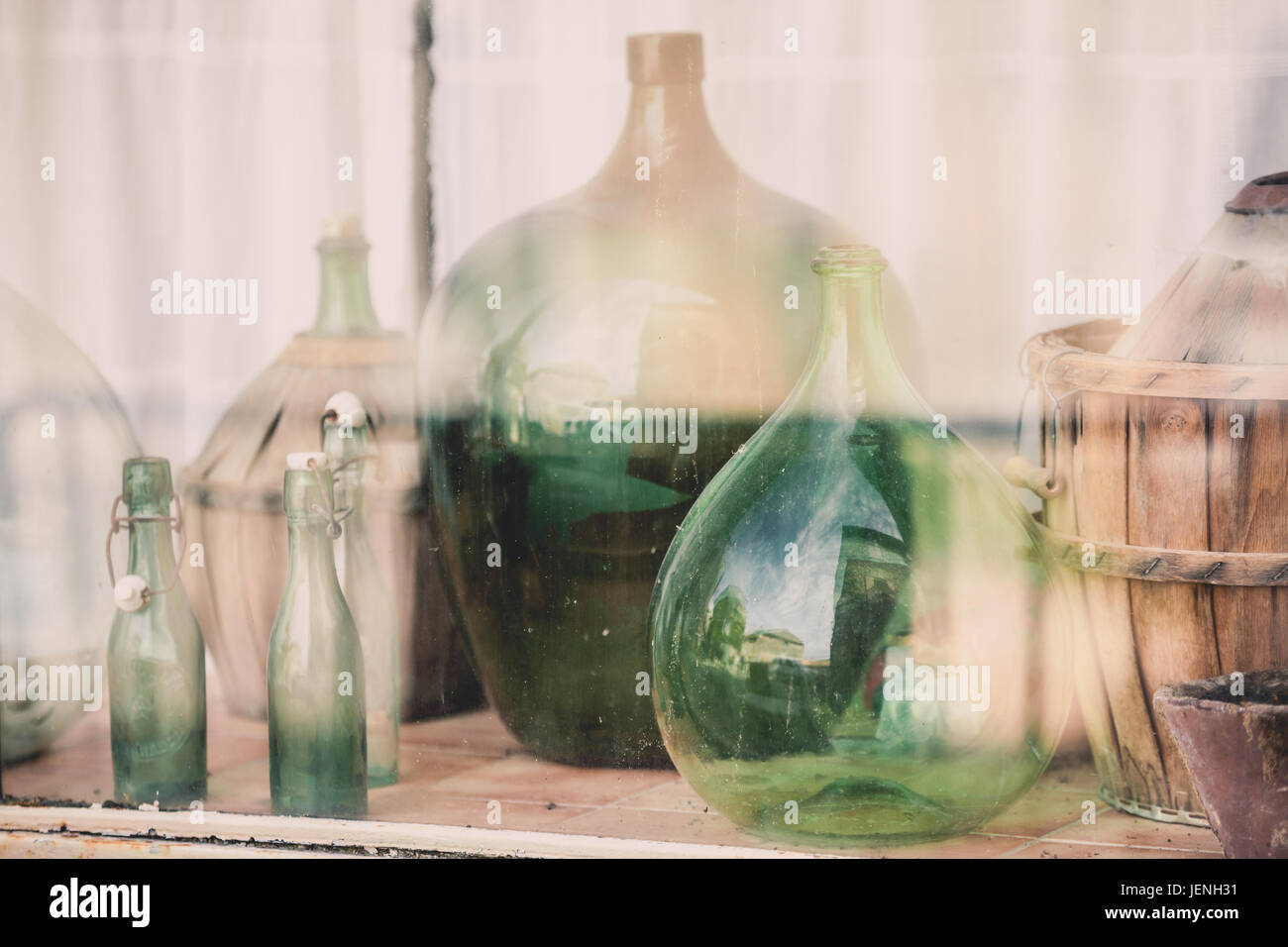 Old empty wine bottles behind the glass with street reflection Stock Photo Alamy