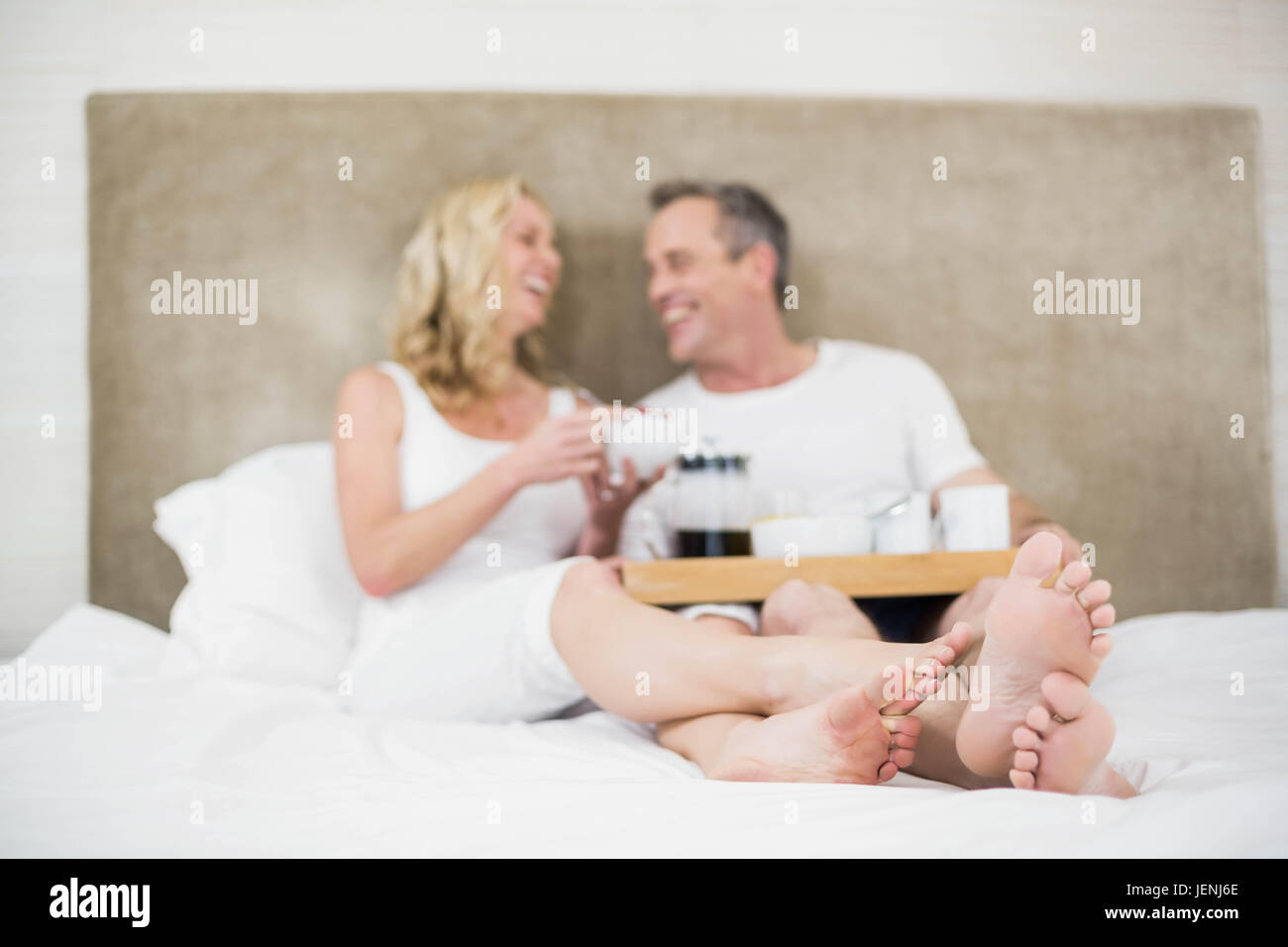 Cute couple having breakfast in bed Stock Photo