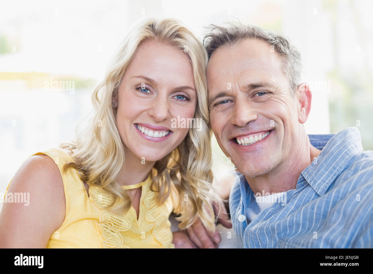 Happy couple smiling at camera Stock Photo - Alamy