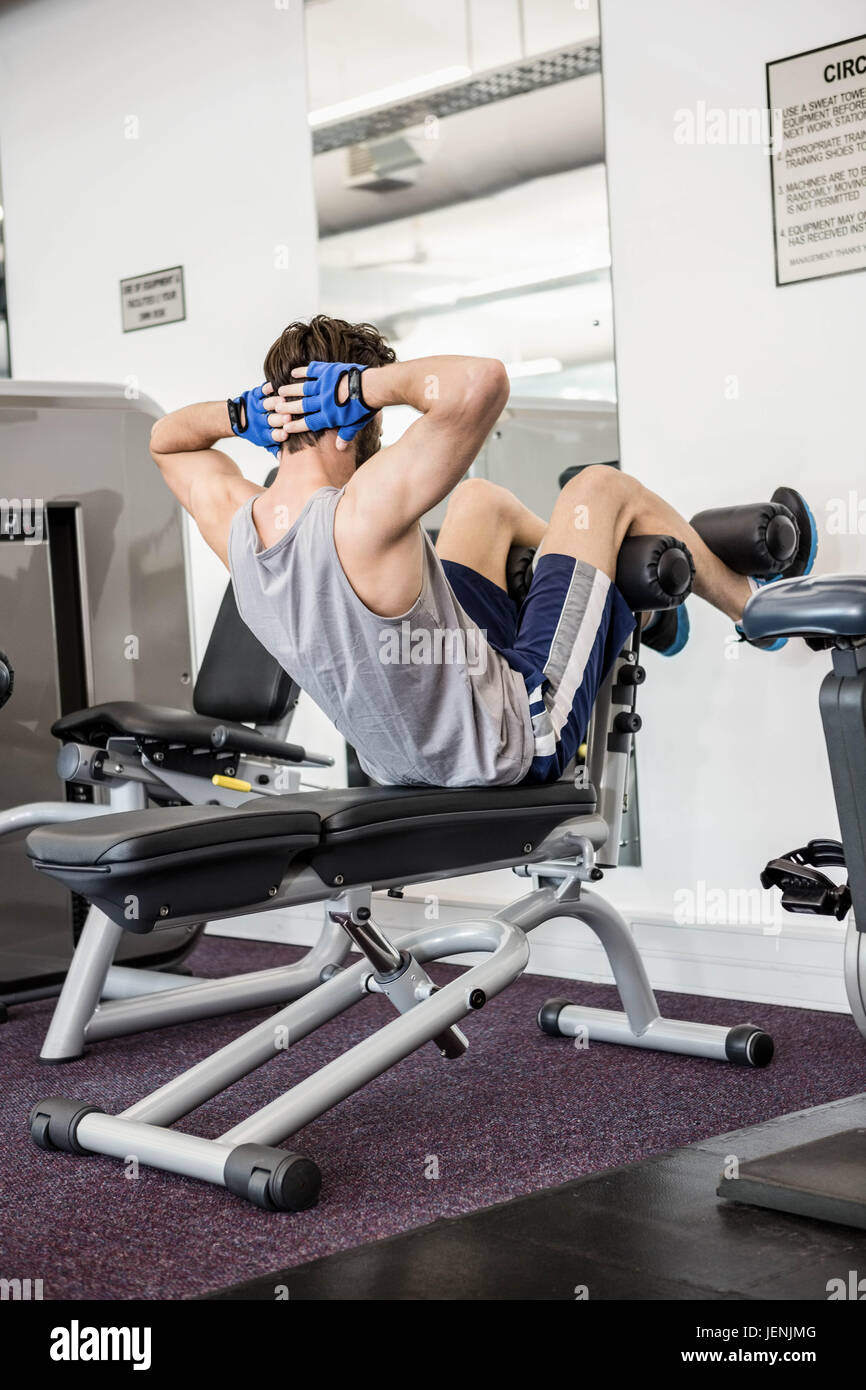 Man doing abdominal crunches on bench Stock Photo Alamy