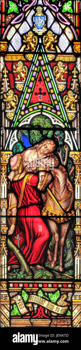 Good Samaritan Parable, Samaritan carries injured traveller, to an inn, for care, 'and brought him to an inn', stained glass window Stock Photo