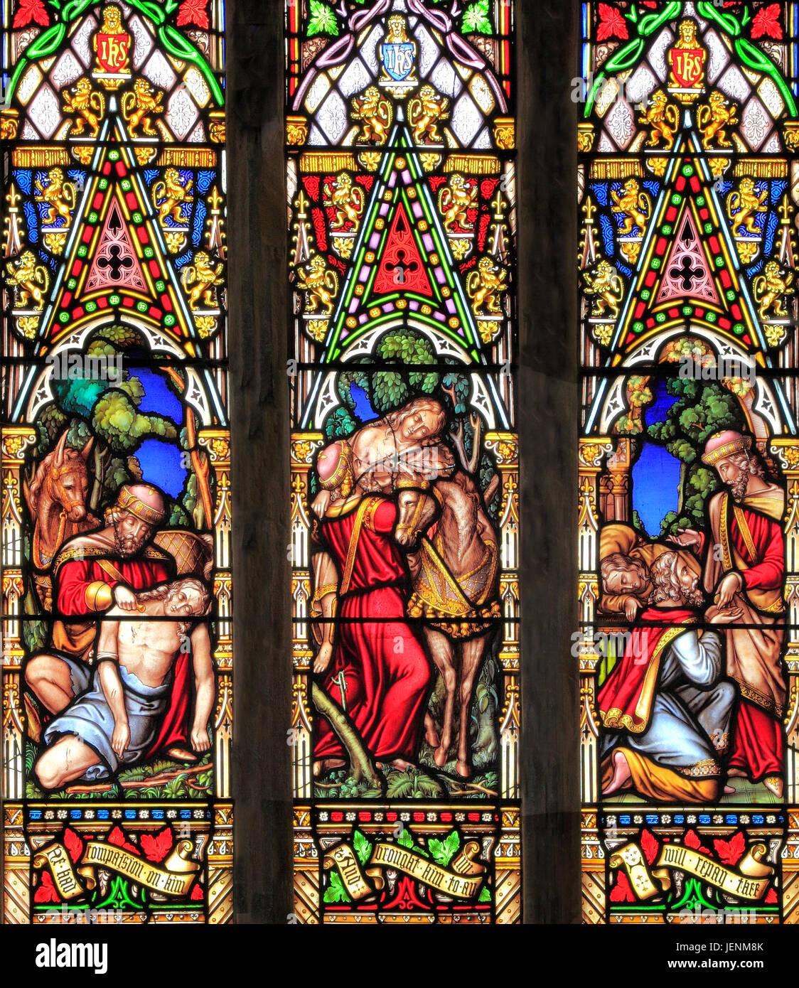 Good Samaritan Parable, tending traveller's injuries, carring him to an Inn, for care, paying the innkeeper, stained glass window, by William Warringt Stock Photo