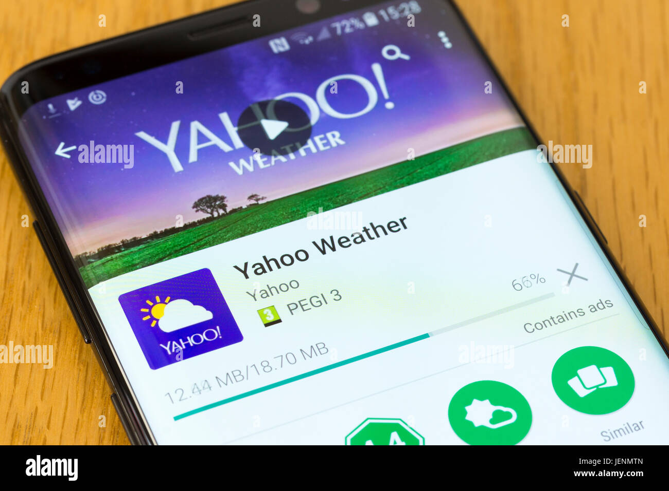 A closeup on the Yahoo Weather app being downloaded on a Samsung Galaxy S8 Stock Photo