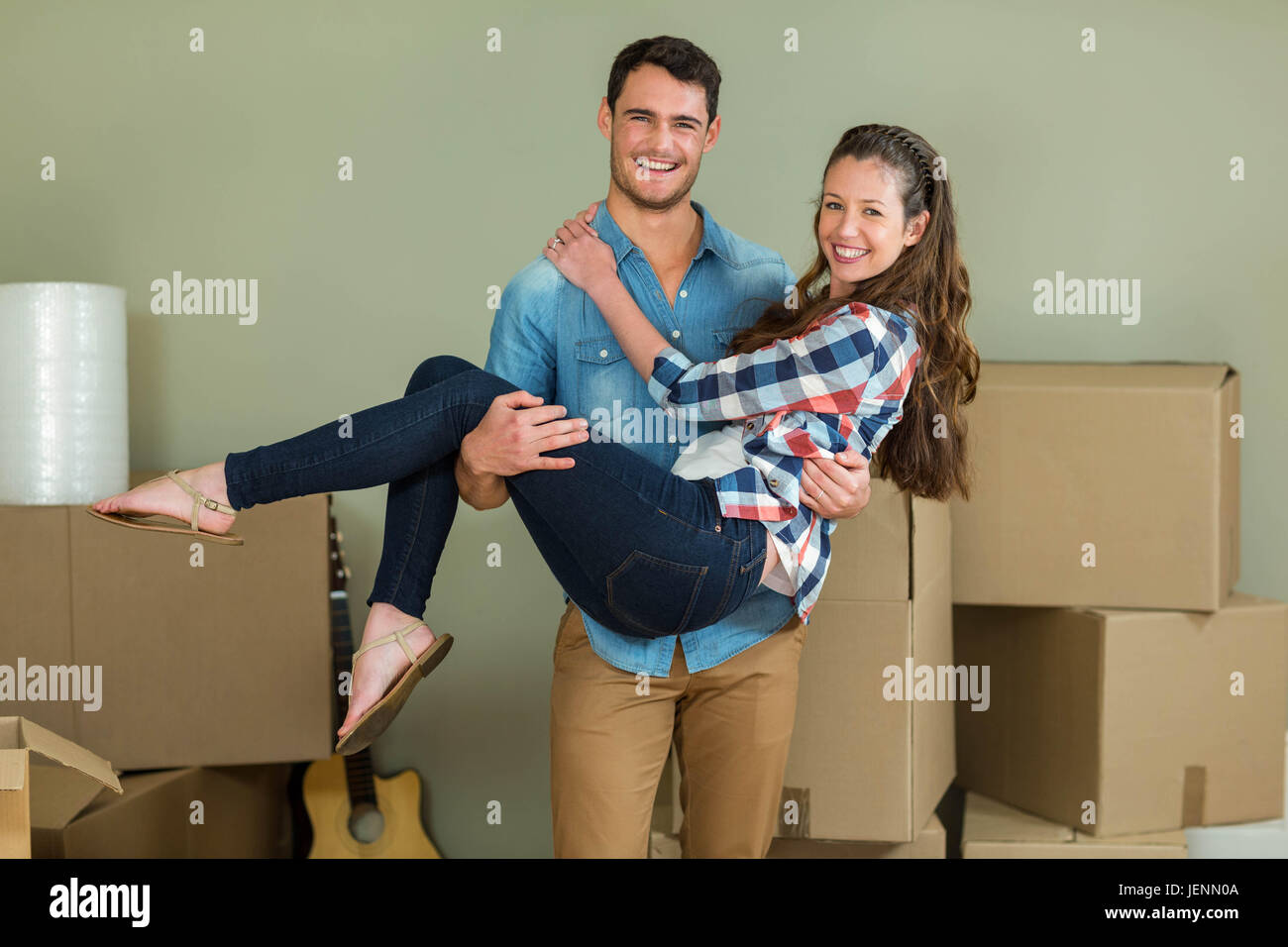 Man lifting woman in his arms Stock Photo - Alamy