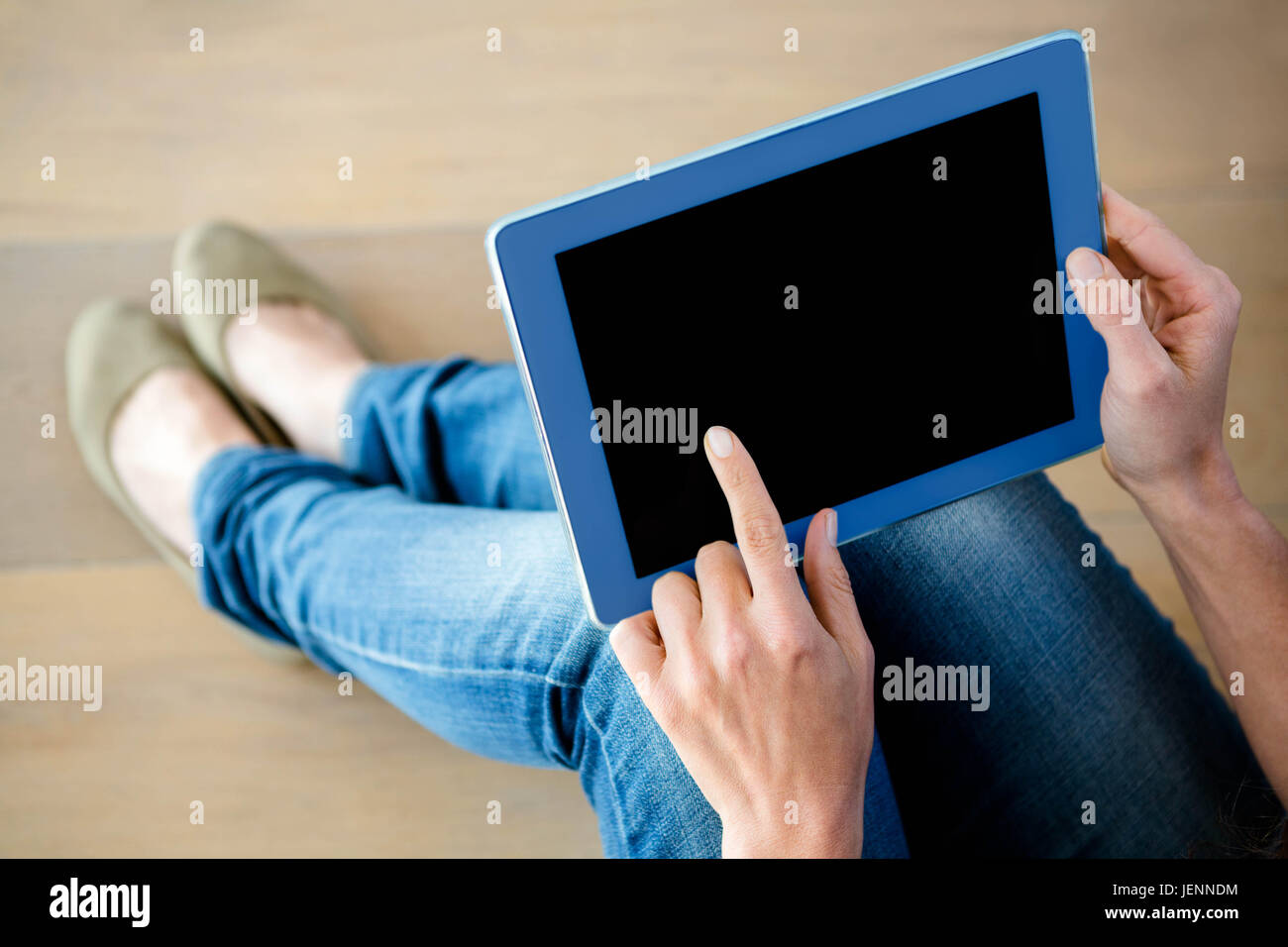 finger tapping a touchscreen tablet Stock Photo