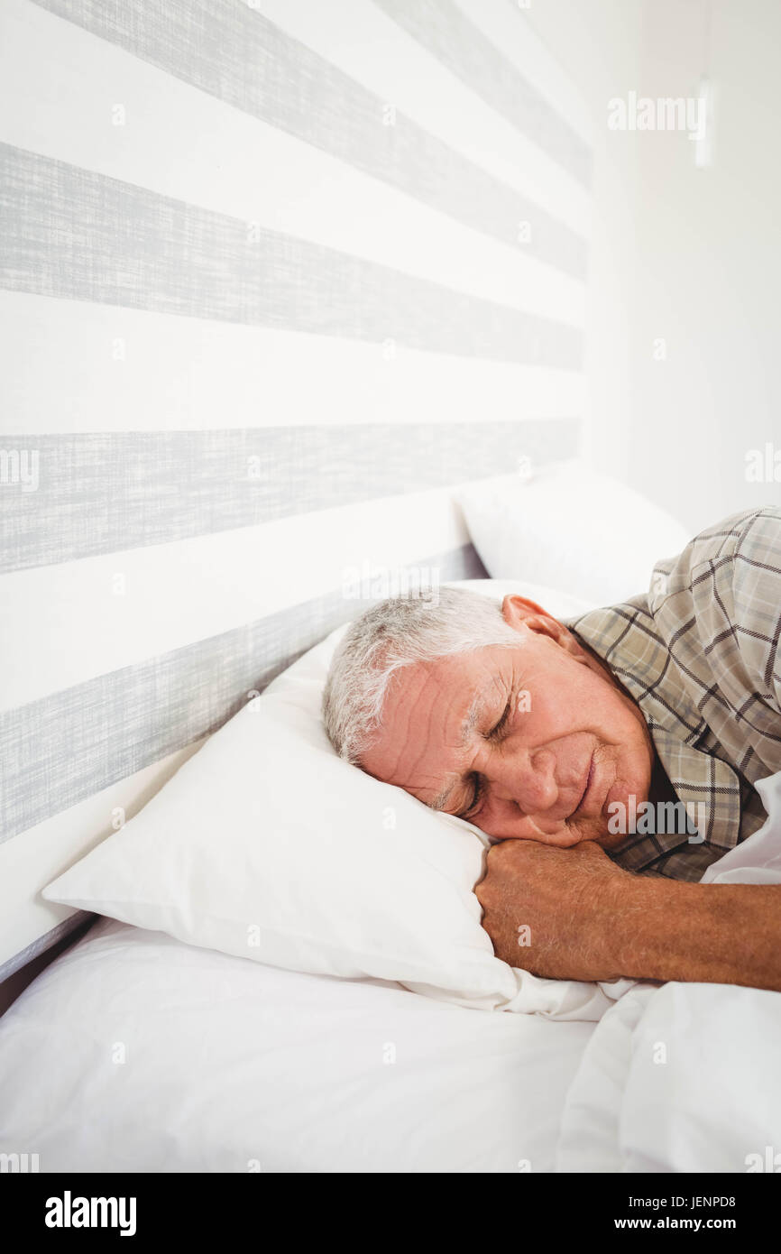 Senior man sleeping on bed Stock Photo - Alamy
