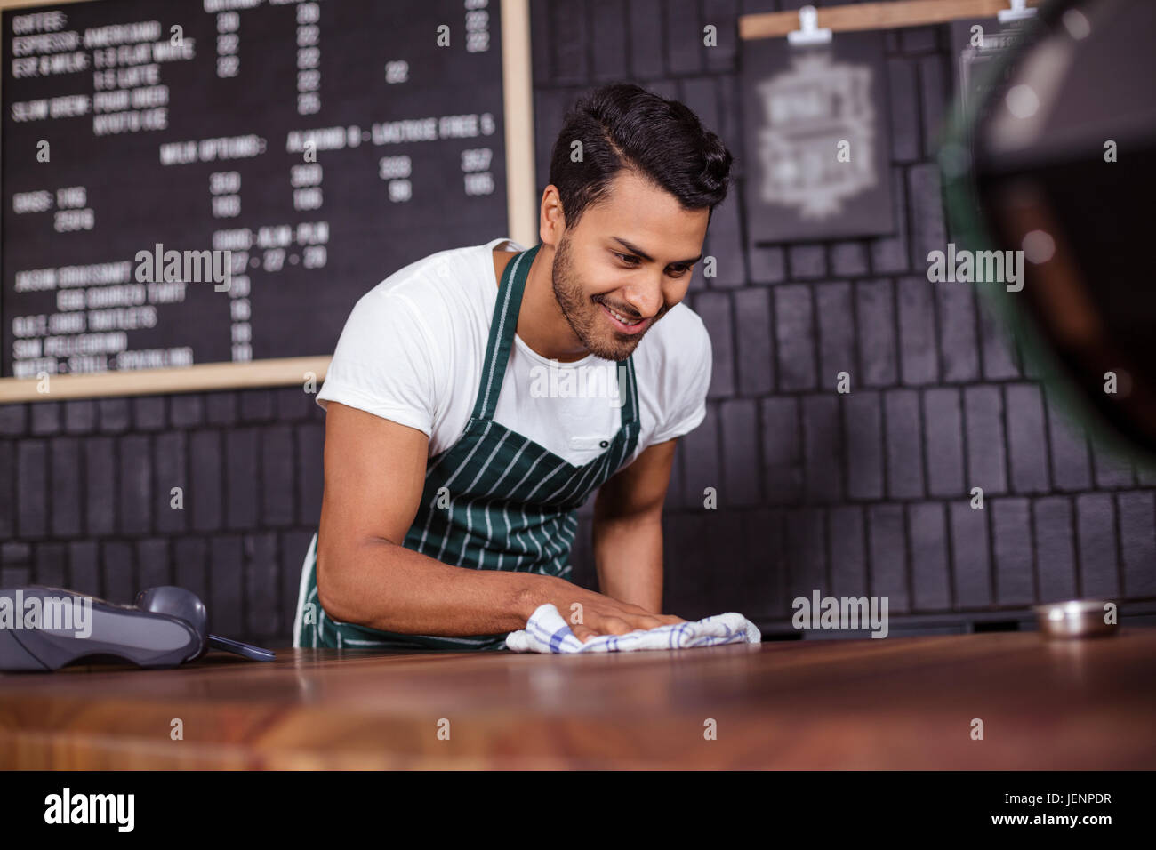 Smiling barista cleaning counter Stock Photo Alamy