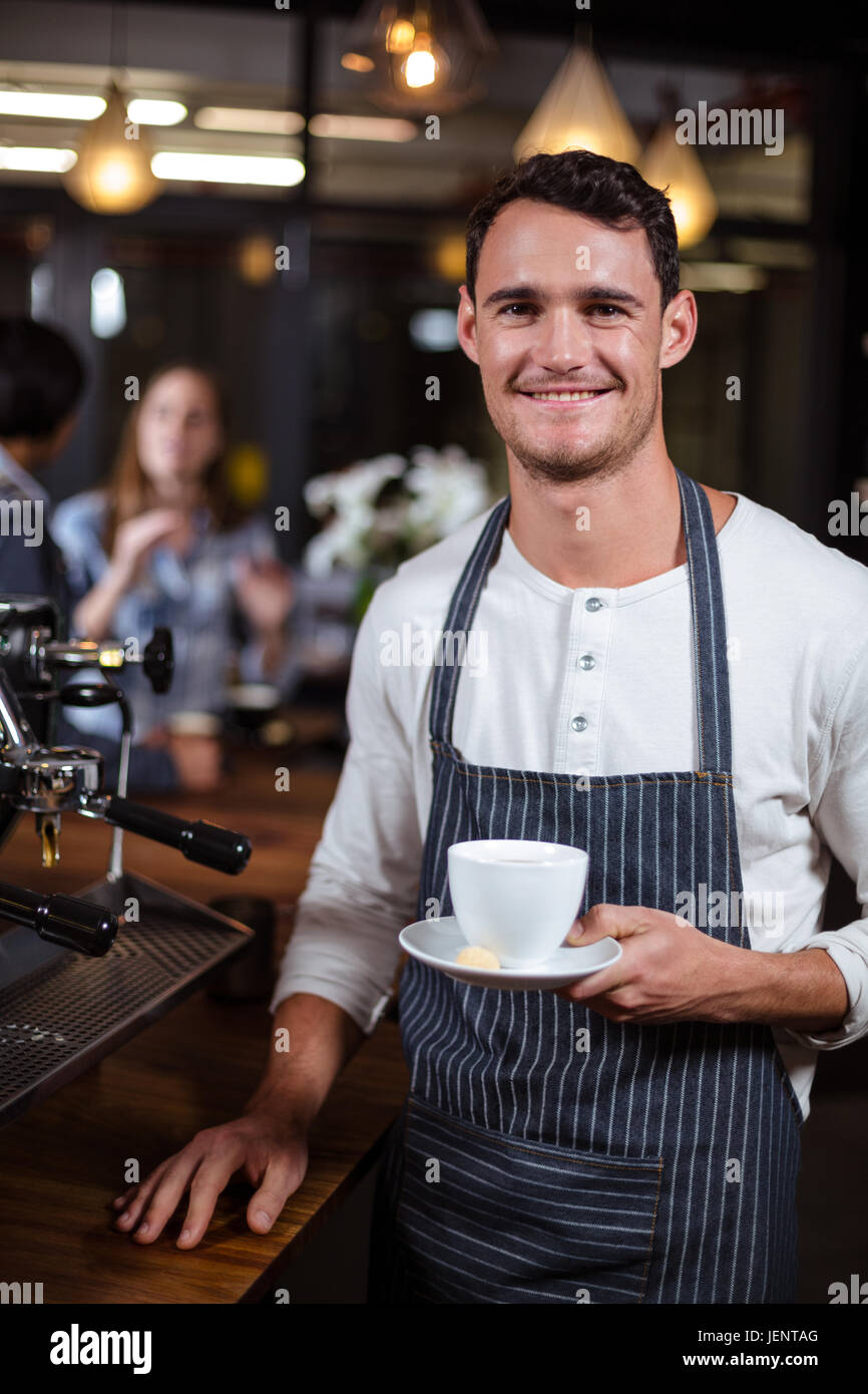 smiling-barista-holding-cappuccino-JENTAG.jpg