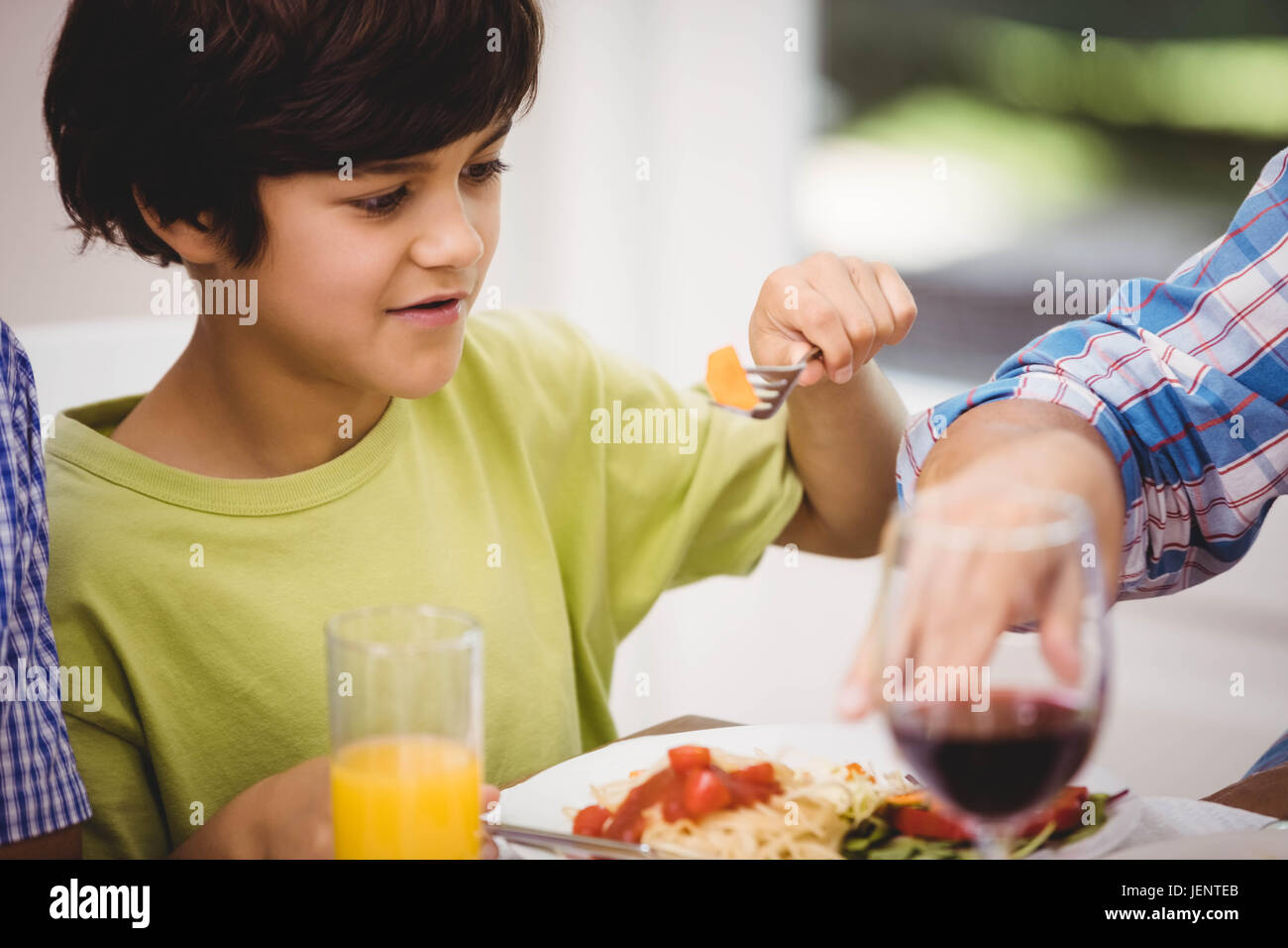 Man and boy sitting at a dining table hi-res stock photography and ...
