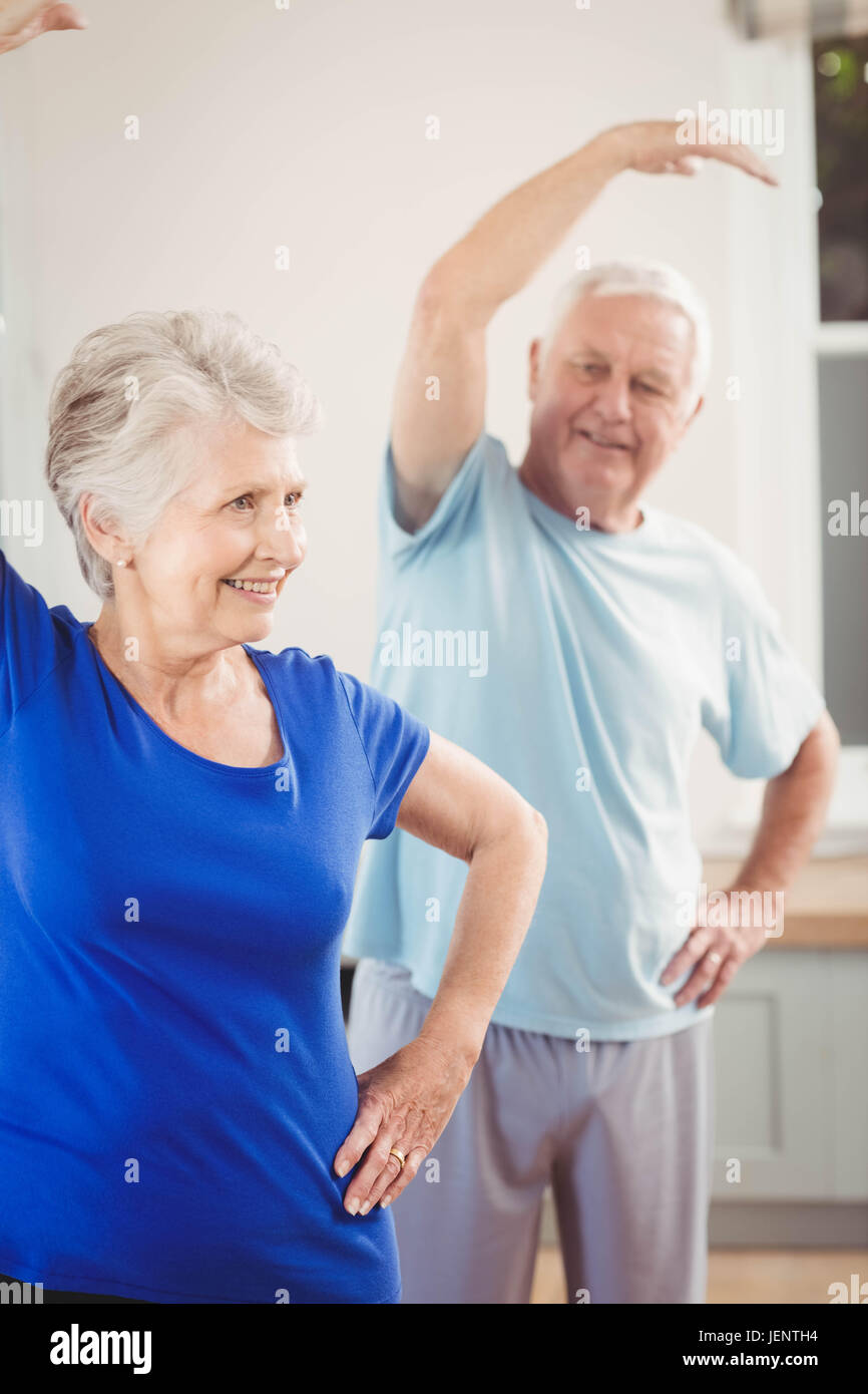 Senior couple performing stretching exercise Stock Photo - Alamy