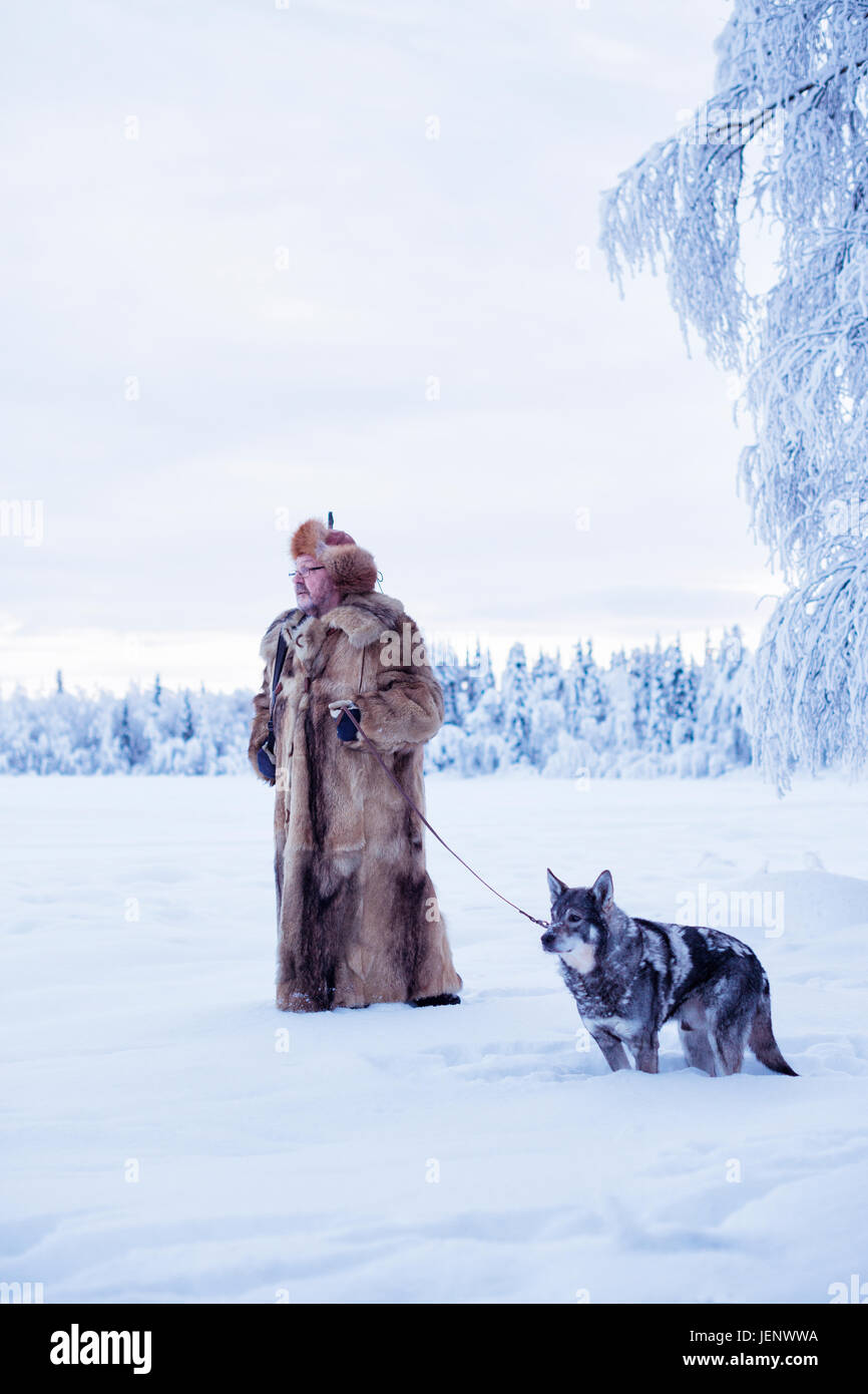 Mature man walking dog at winter Stock Photo