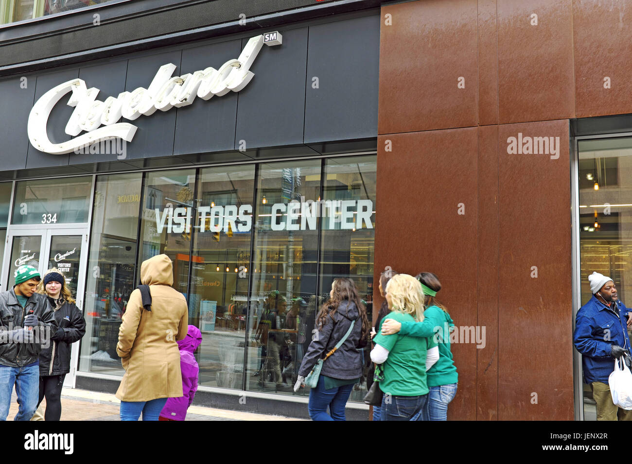 Pedestrians walk by the city of Cleveland visitors center on Euclid Avenue in downtown Cleveland, Ohio, USA on a chilly March afternoon. Stock Photo