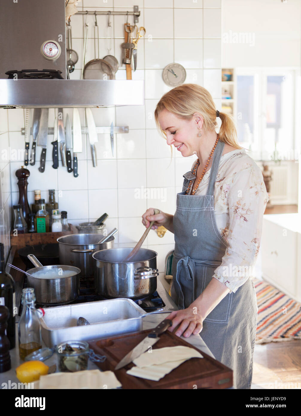 Smiling woman cooking Stock Photo - Alamy