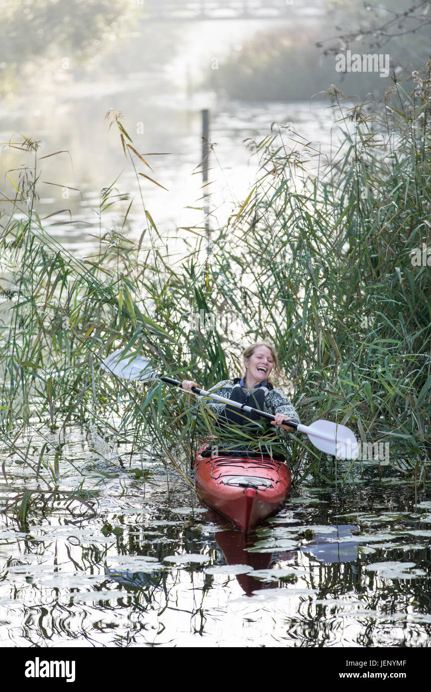 Woman kayaking in fog Stock Photo Alamy