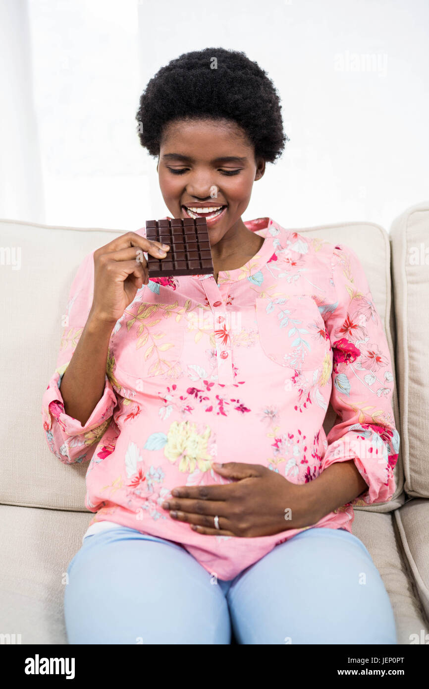 Pregnant woman eating chocolate Stock Photo Alamy