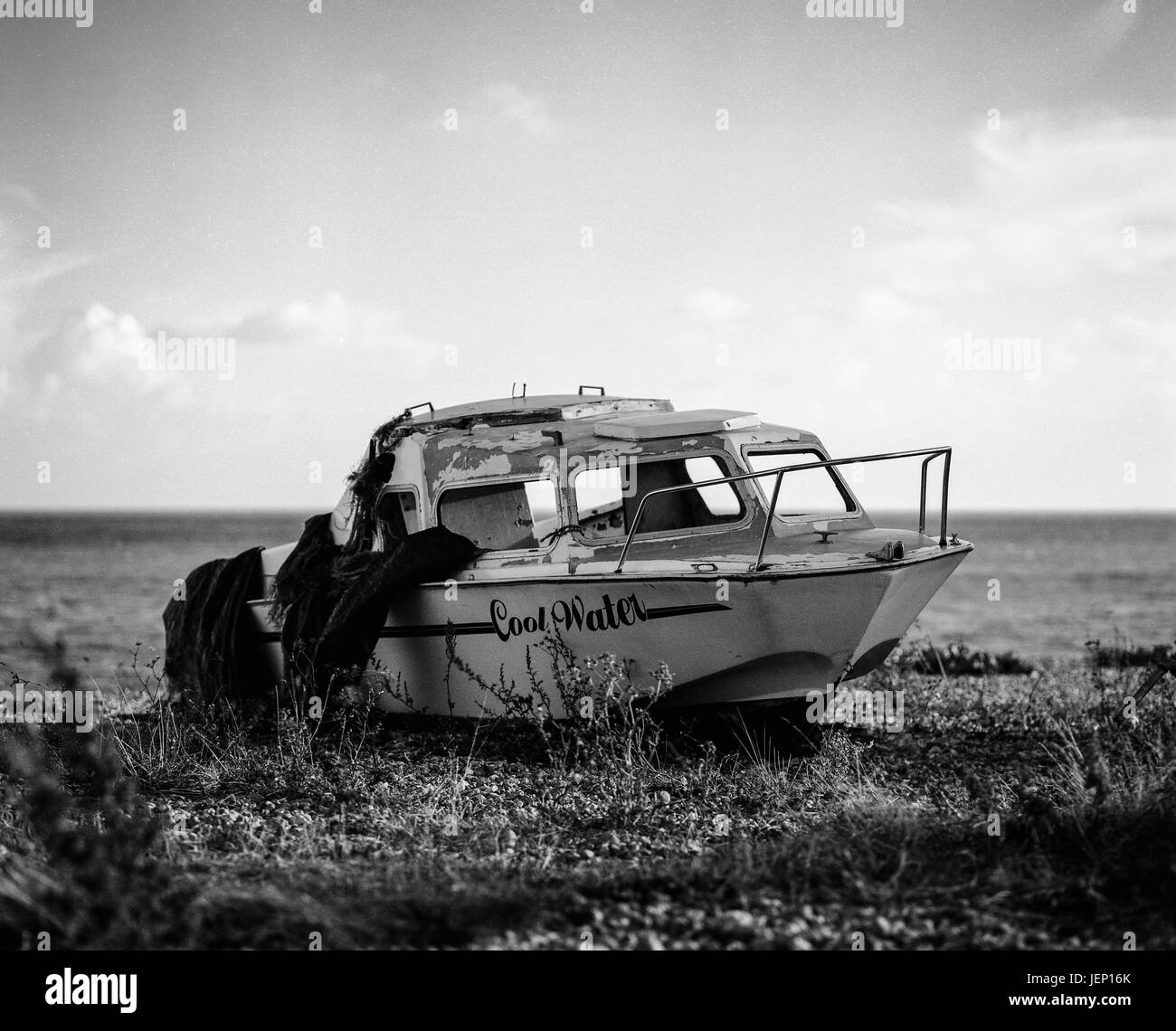 Boat left abandoned on beach, photographed with a Mamiya Rb67 film camera and some black and white film Stock Photo