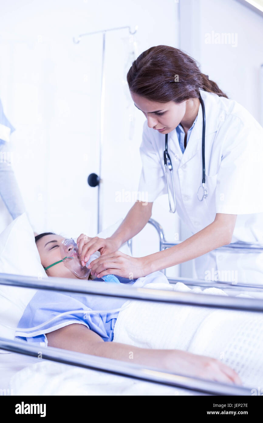 Doctor putting an oxygen mask on patient Stock Photo Alamy