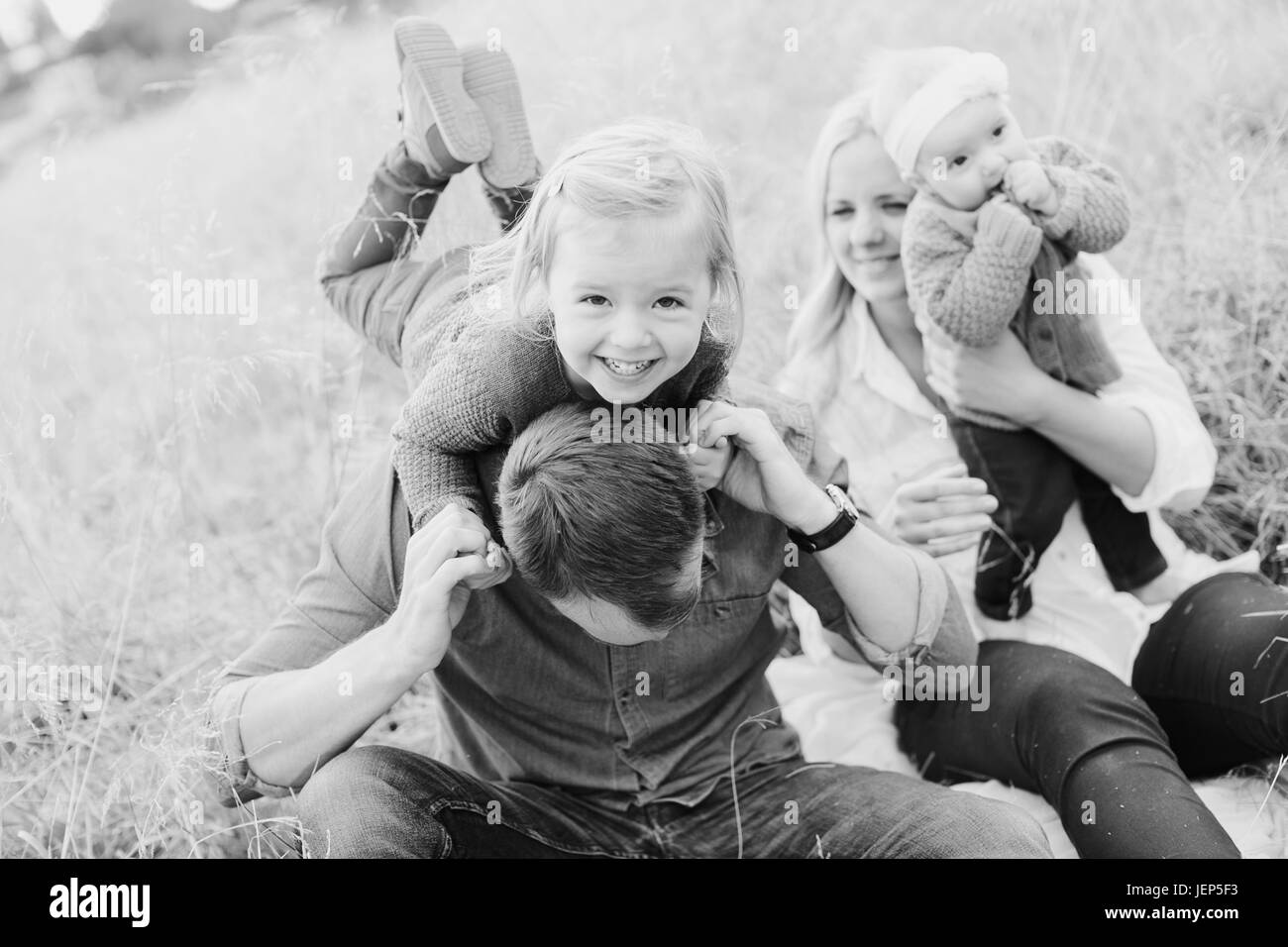 Parents with children on meadow Stock Photo