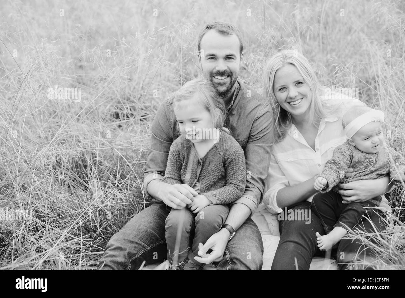 Parents with children on meadow Stock Photo