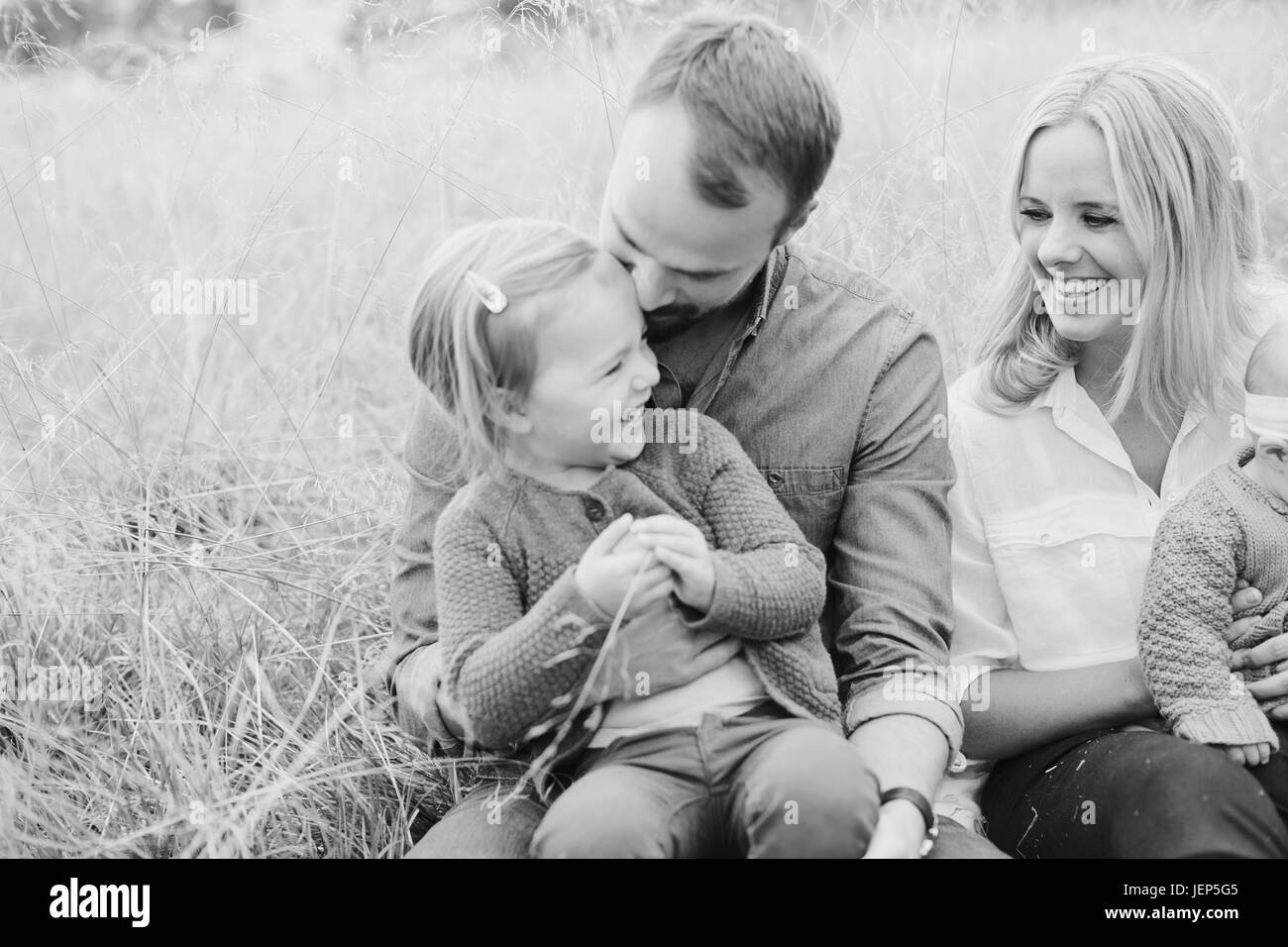 Parents with children on meadow Stock Photo